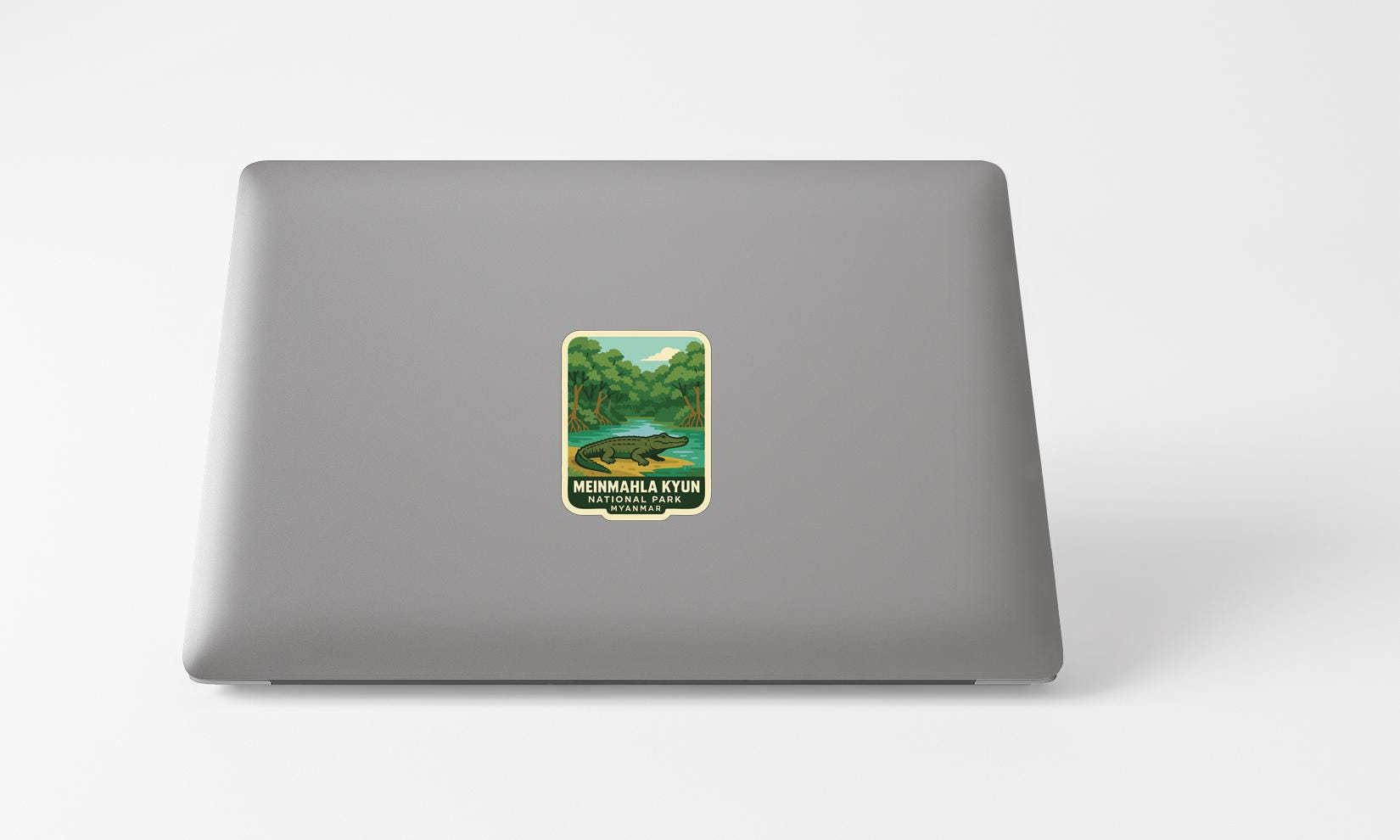 A sticker with a landscape image on a laptop.