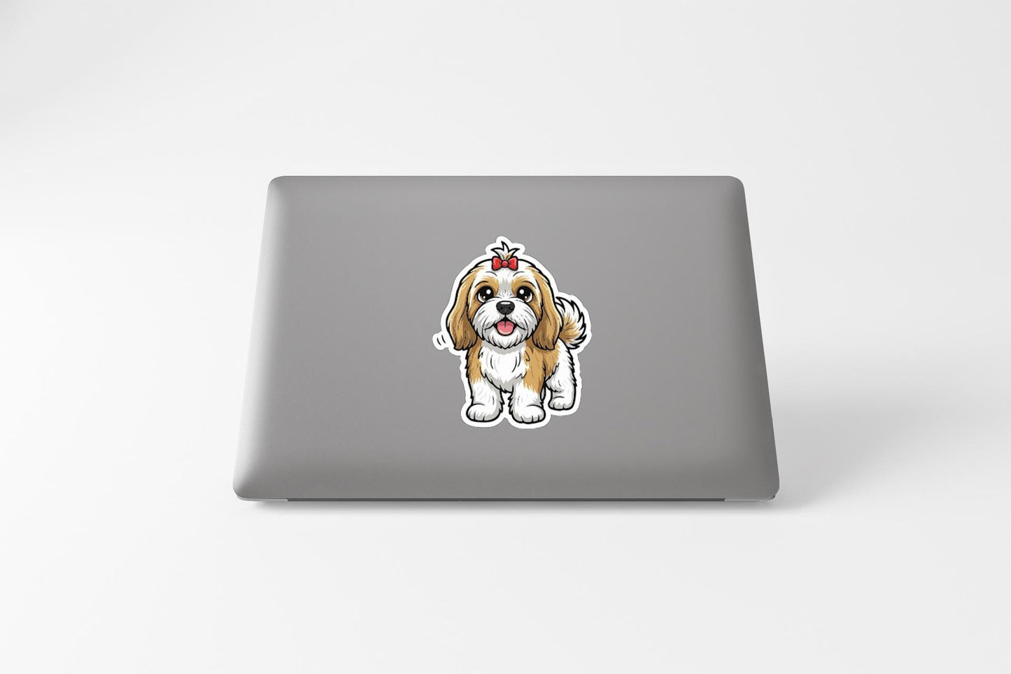 A sticker of a cartoon dog on the back of a laptop computer.