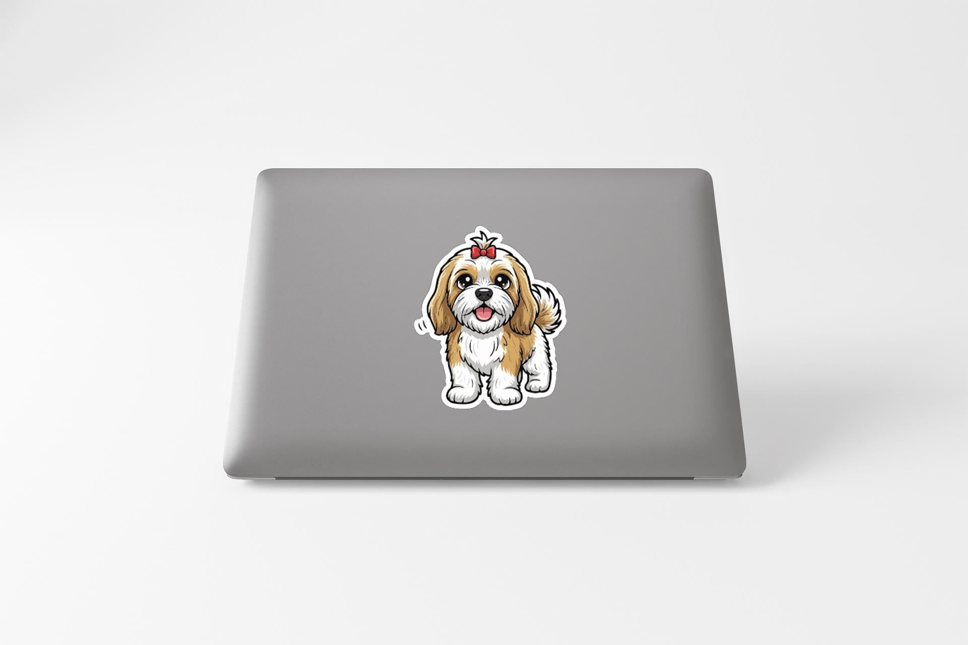 A sticker of a cartoon dog on the back of a laptop computer.