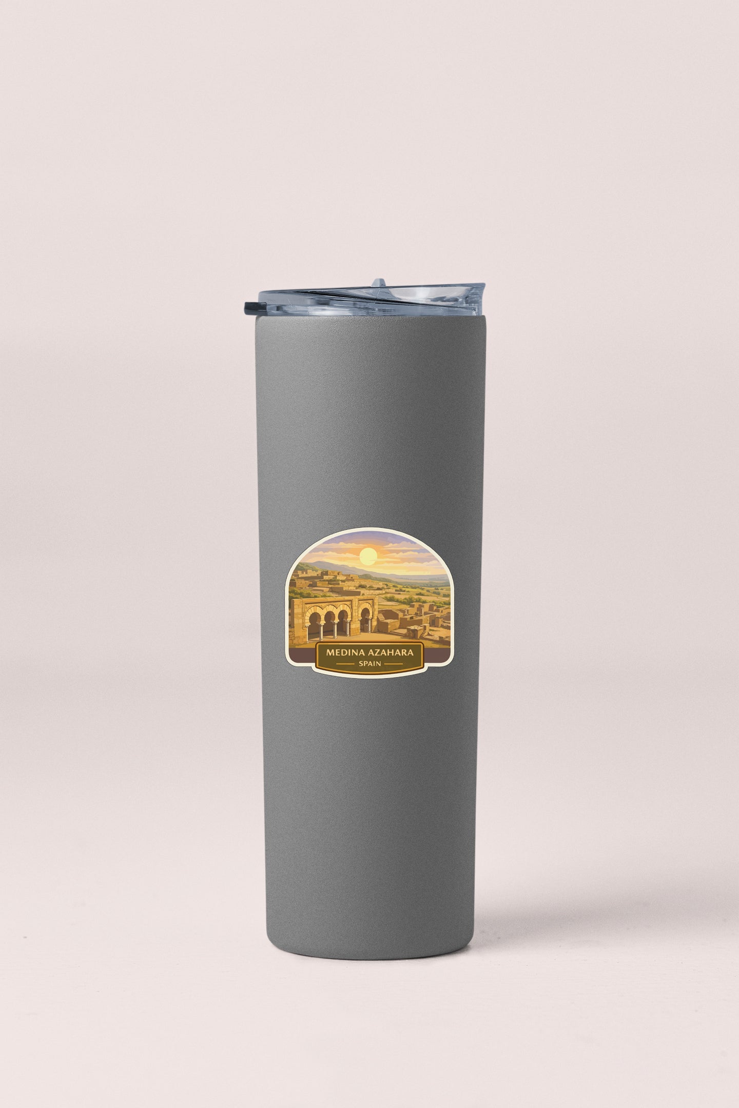 A gray insulated tumbler with a label that says "MEDINA AZHARA" and "SPAIN".