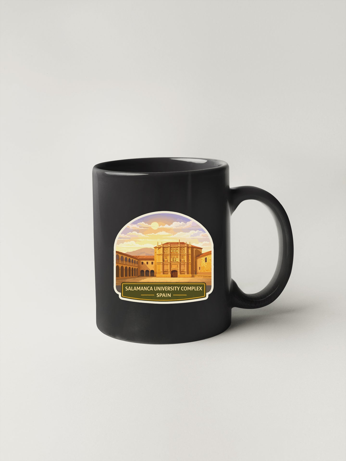 A black coffee mug with a graphic design depicting the Valamanca University Complex in Spain.