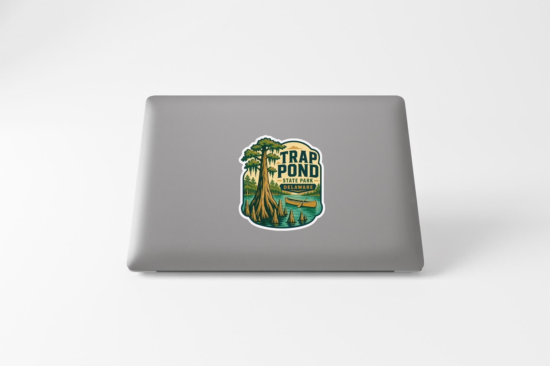 A sticker on the back of a laptop that says "Trap Pond State Park".