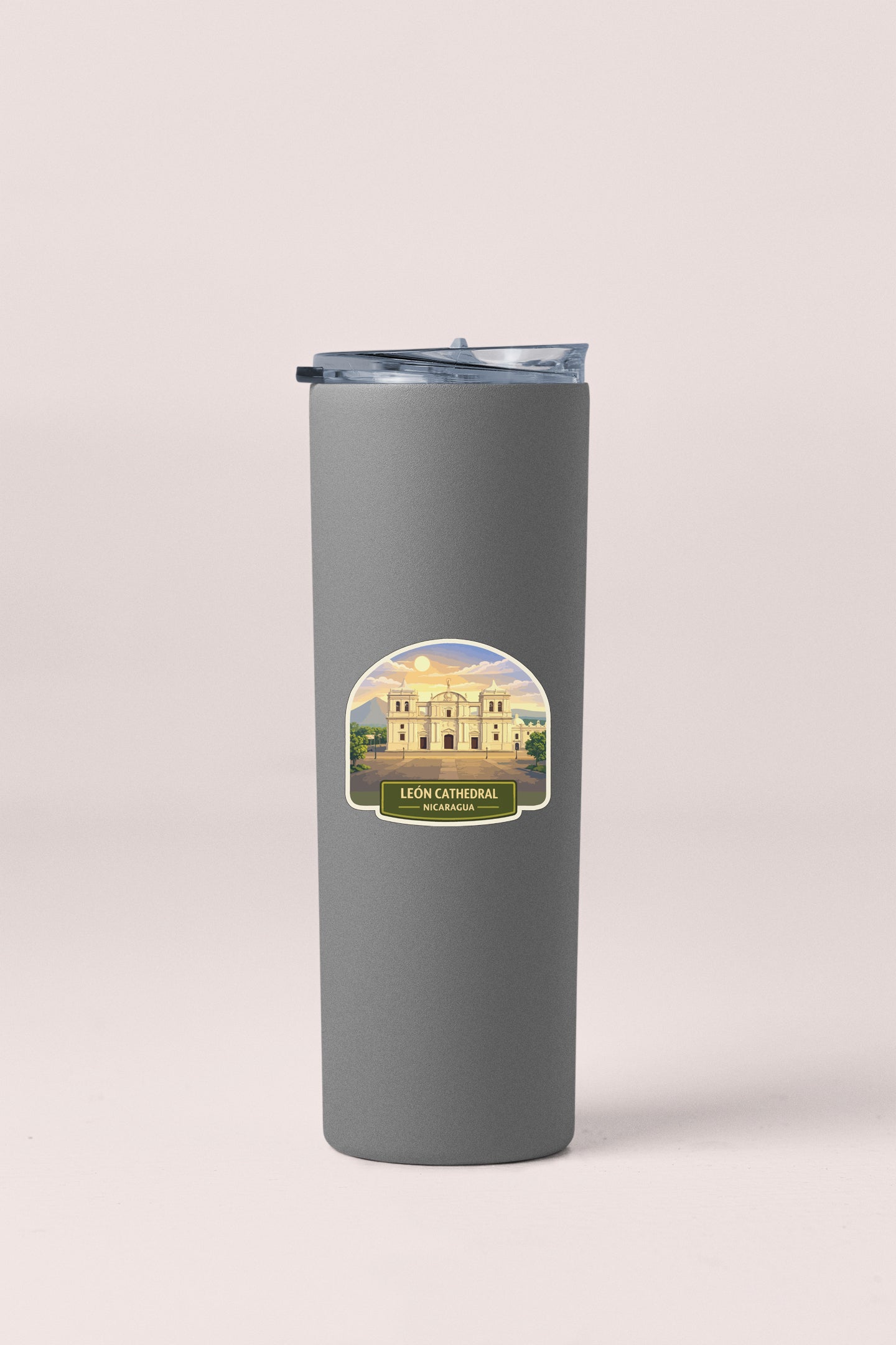 A gray insulated tumbler with a label that features an illustration of a building and the text "LEON CATHEDRAL NACOGUA".