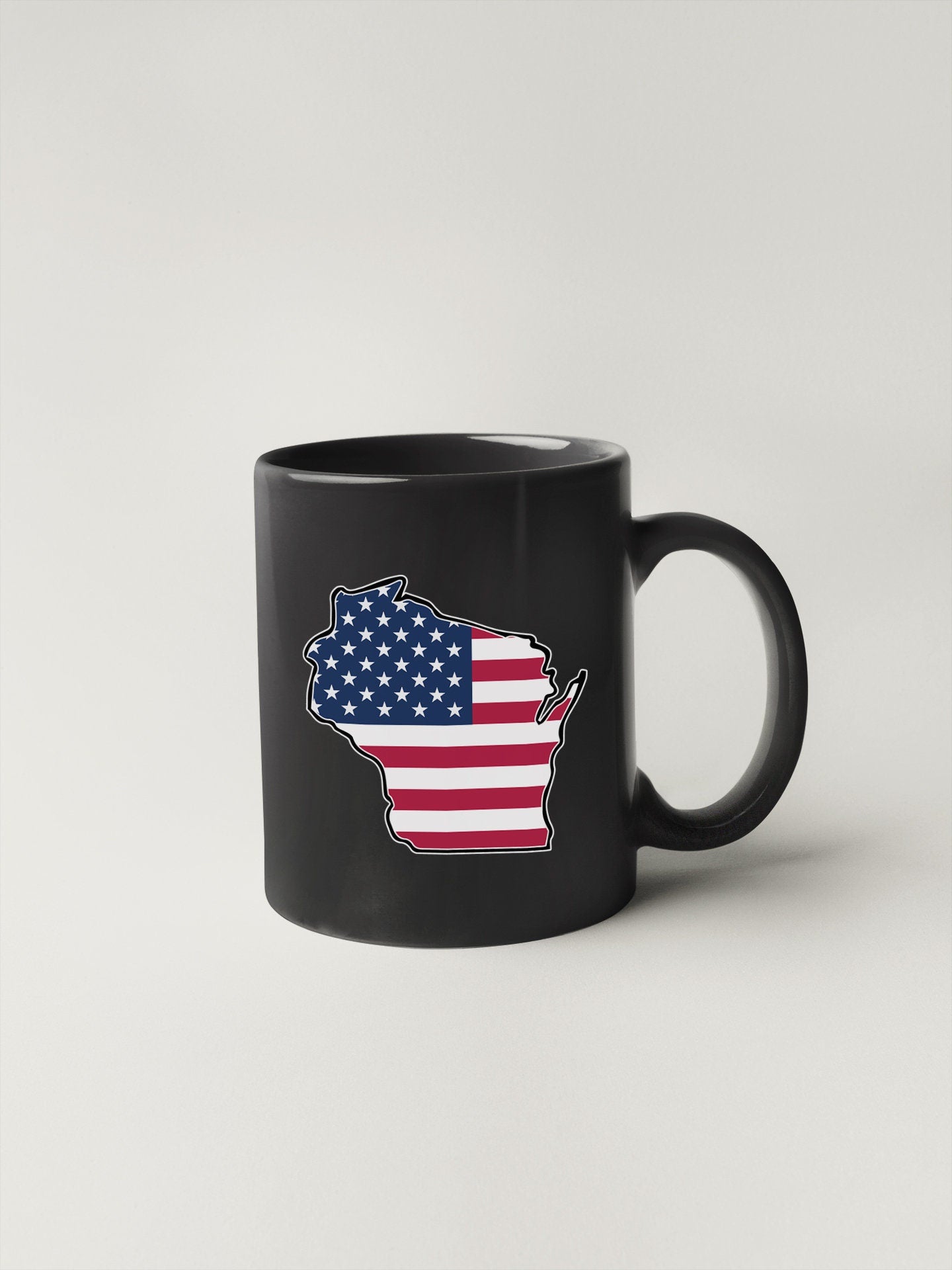 a black coffee mug with a map of the united states painted on it