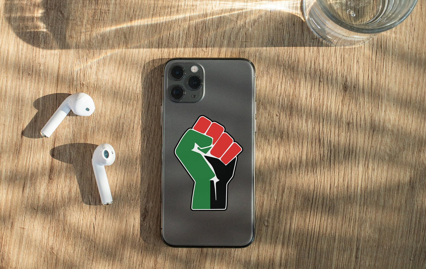 a cell phone with a sticker of a fist on it