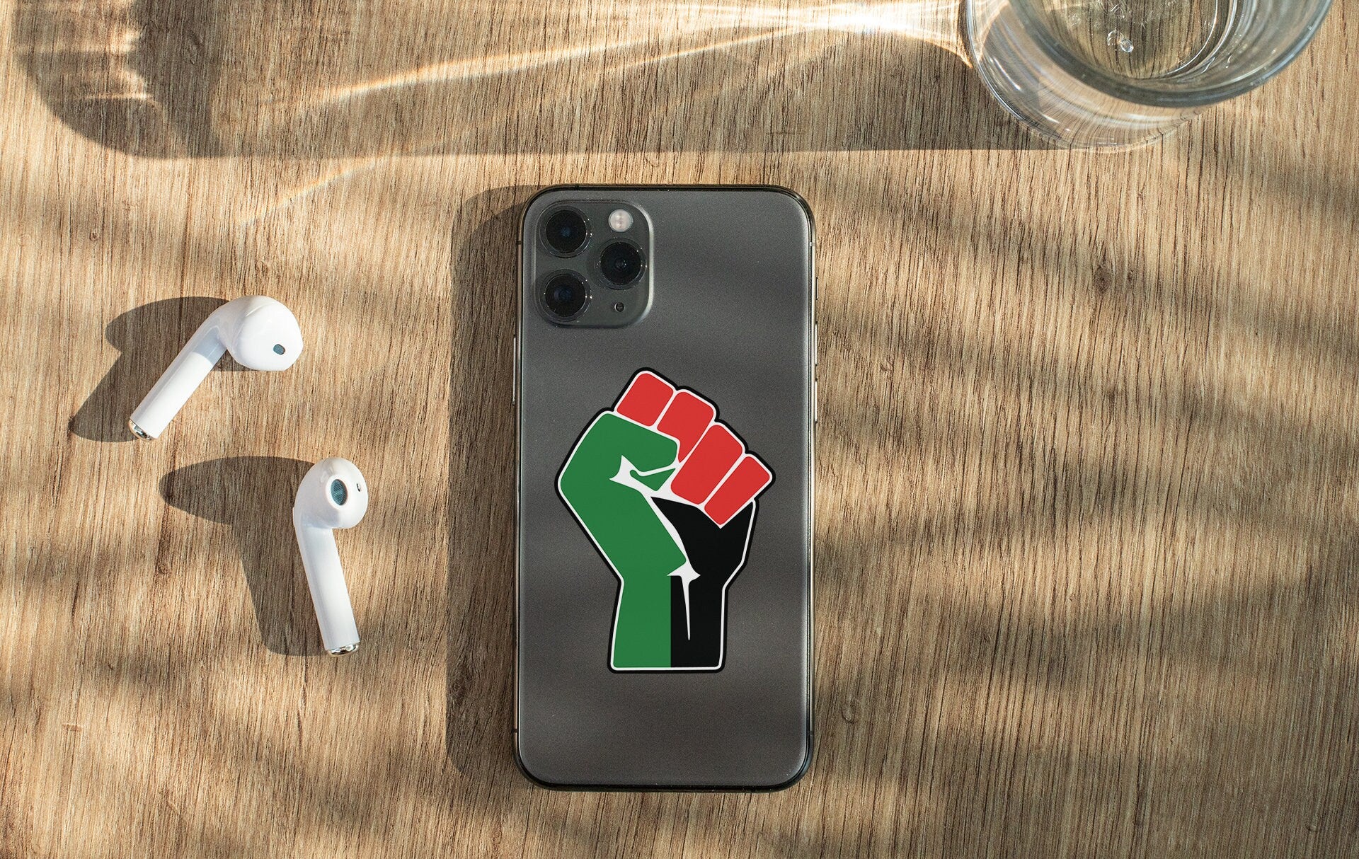 a cell phone with a sticker of a fist on it