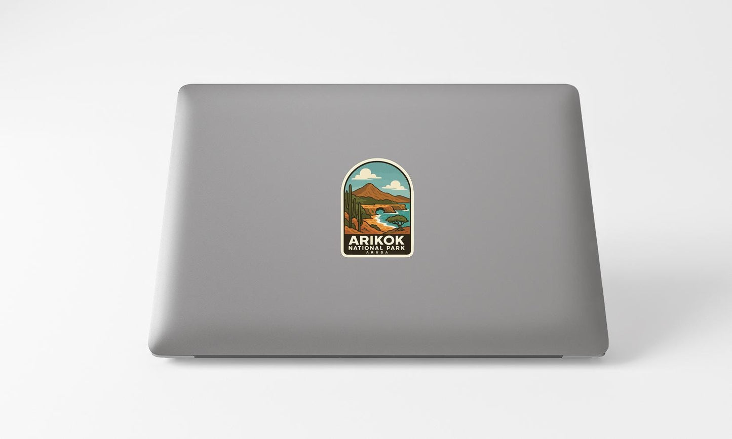 A sticker on the back of a laptop, depicting a scenic landscape with mountains and a lake.