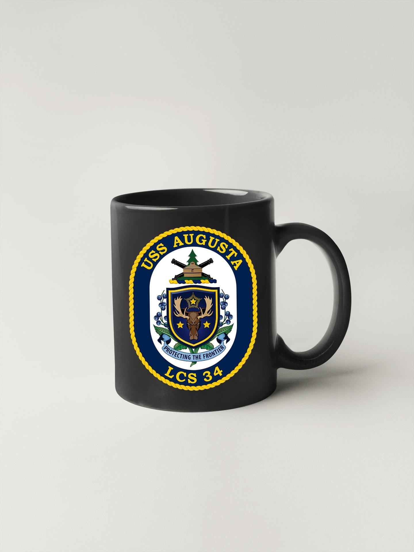 a black coffee mug with the seal of the us navy