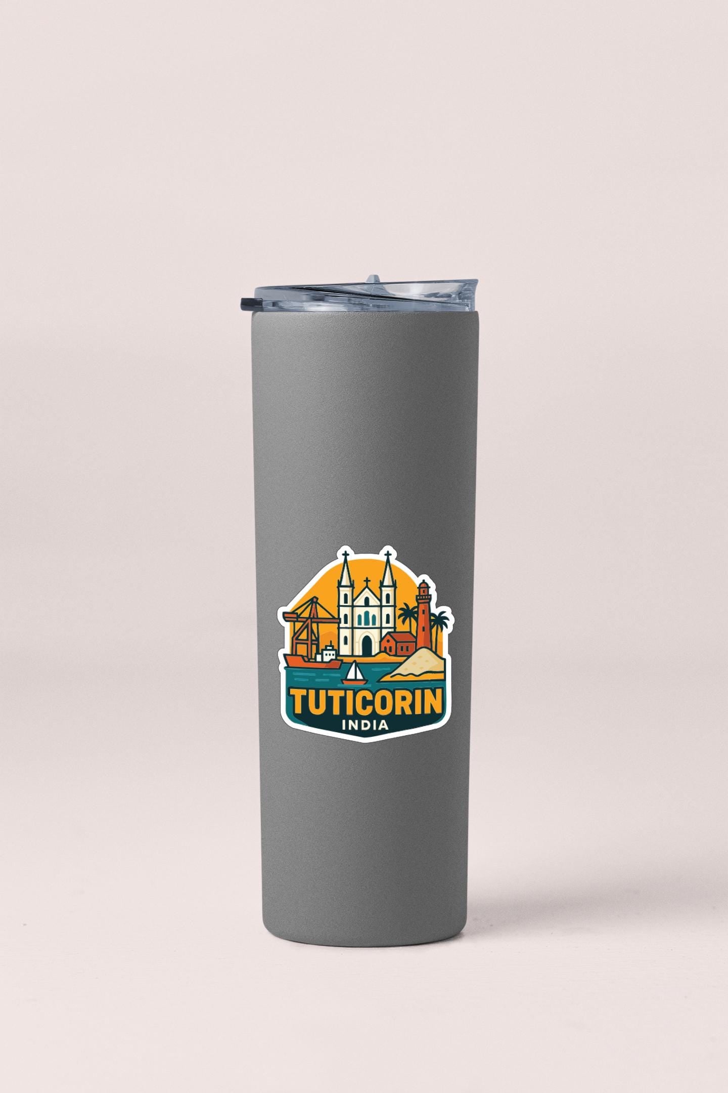 A gray insulated tumbler with a logo depicting a city skyline and the text "TUTICORIN INDIA" printed on it.