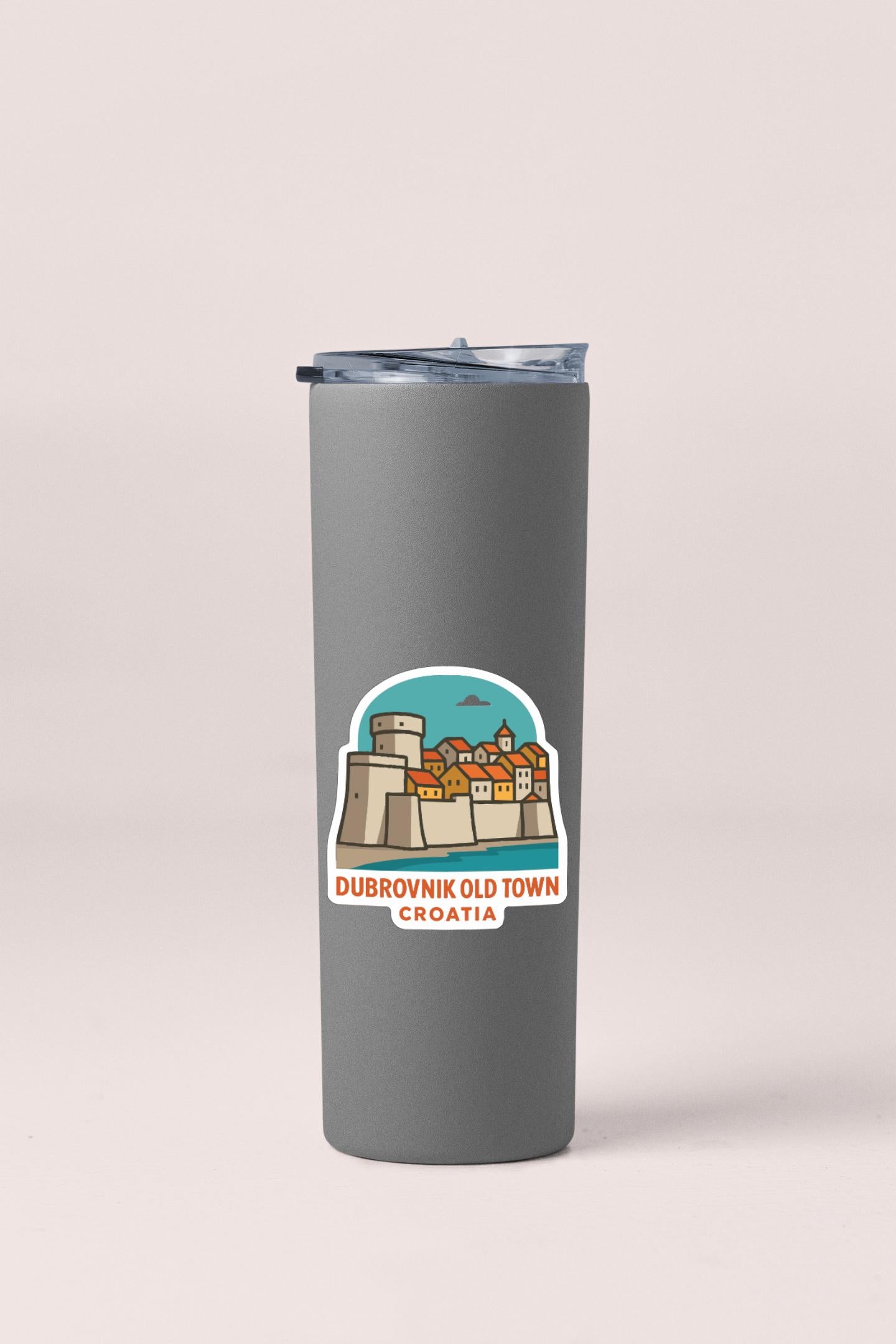 A gray insulated tumbler with a sticker depicting Dubrovnik Old Town Croatia.