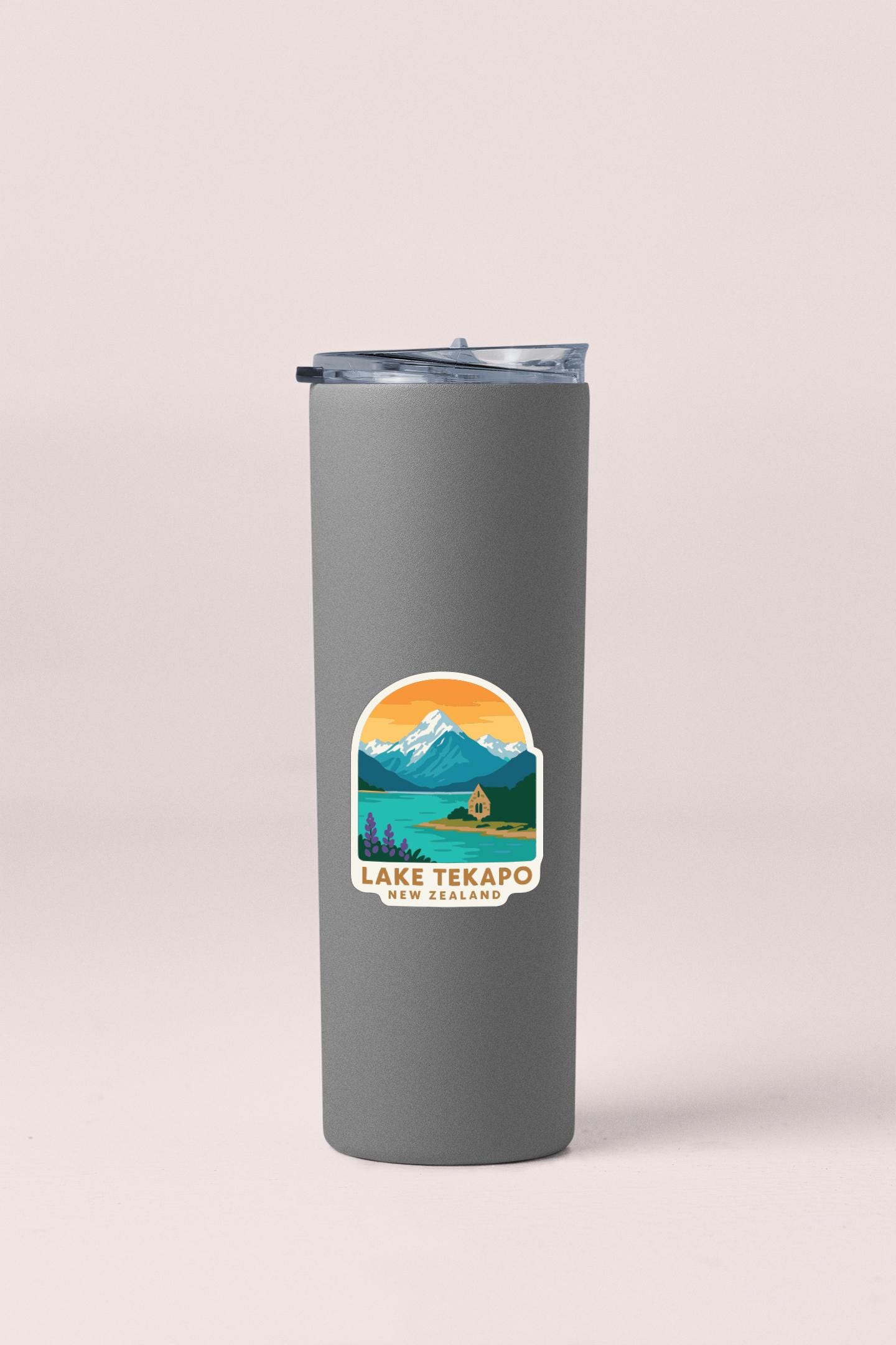A gray insulated tumbler with a label that says "Lake Tekapo New Zealand".