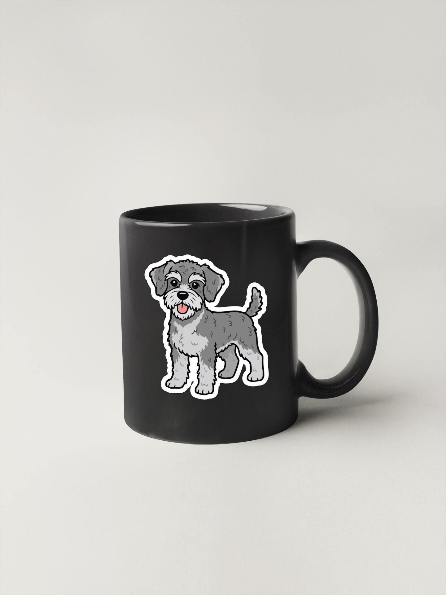 A black mug with a cartoon illustration of a dog on it.