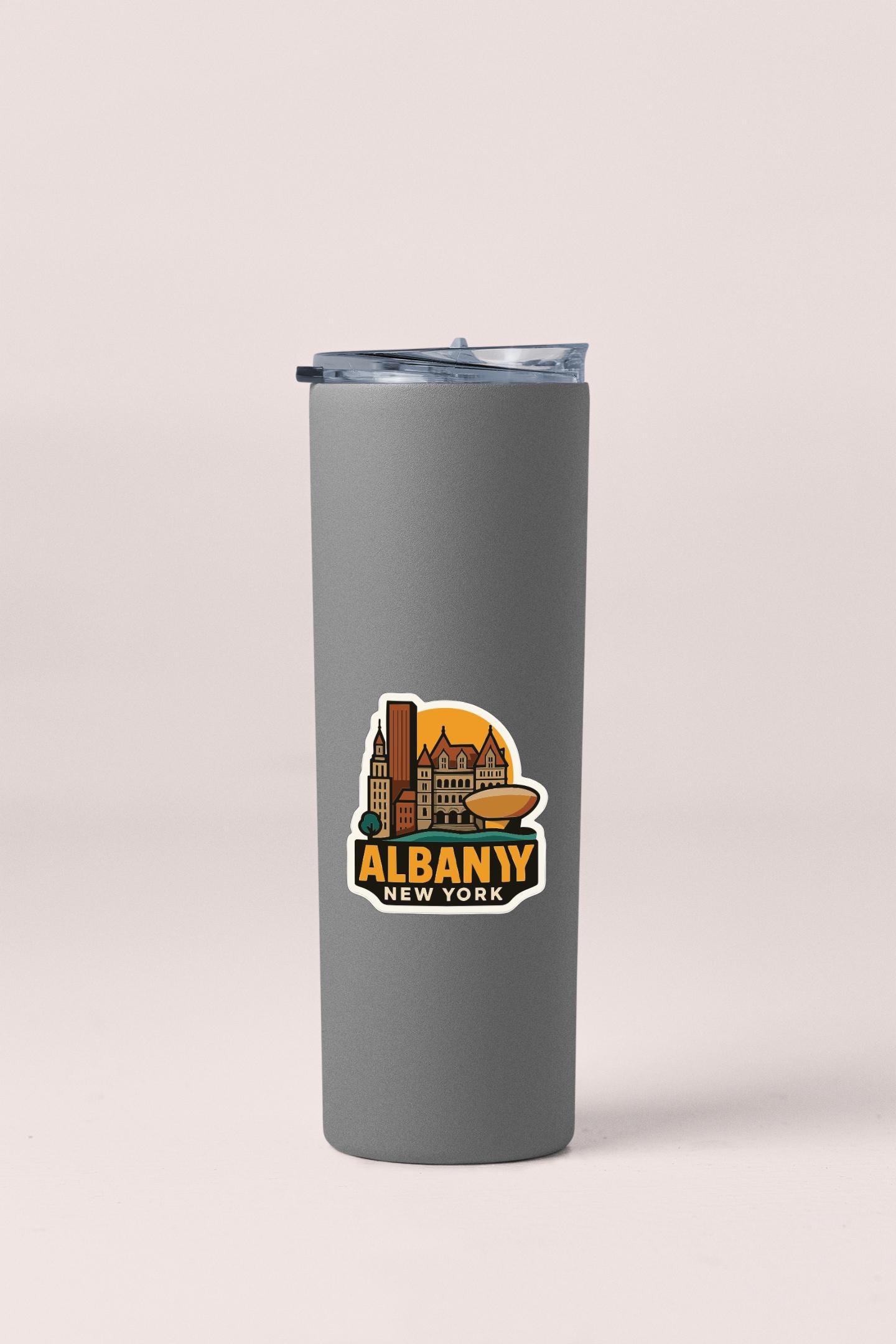 A gray insulated tumbler with a sticker depicting the city of Albaniy, New York.
