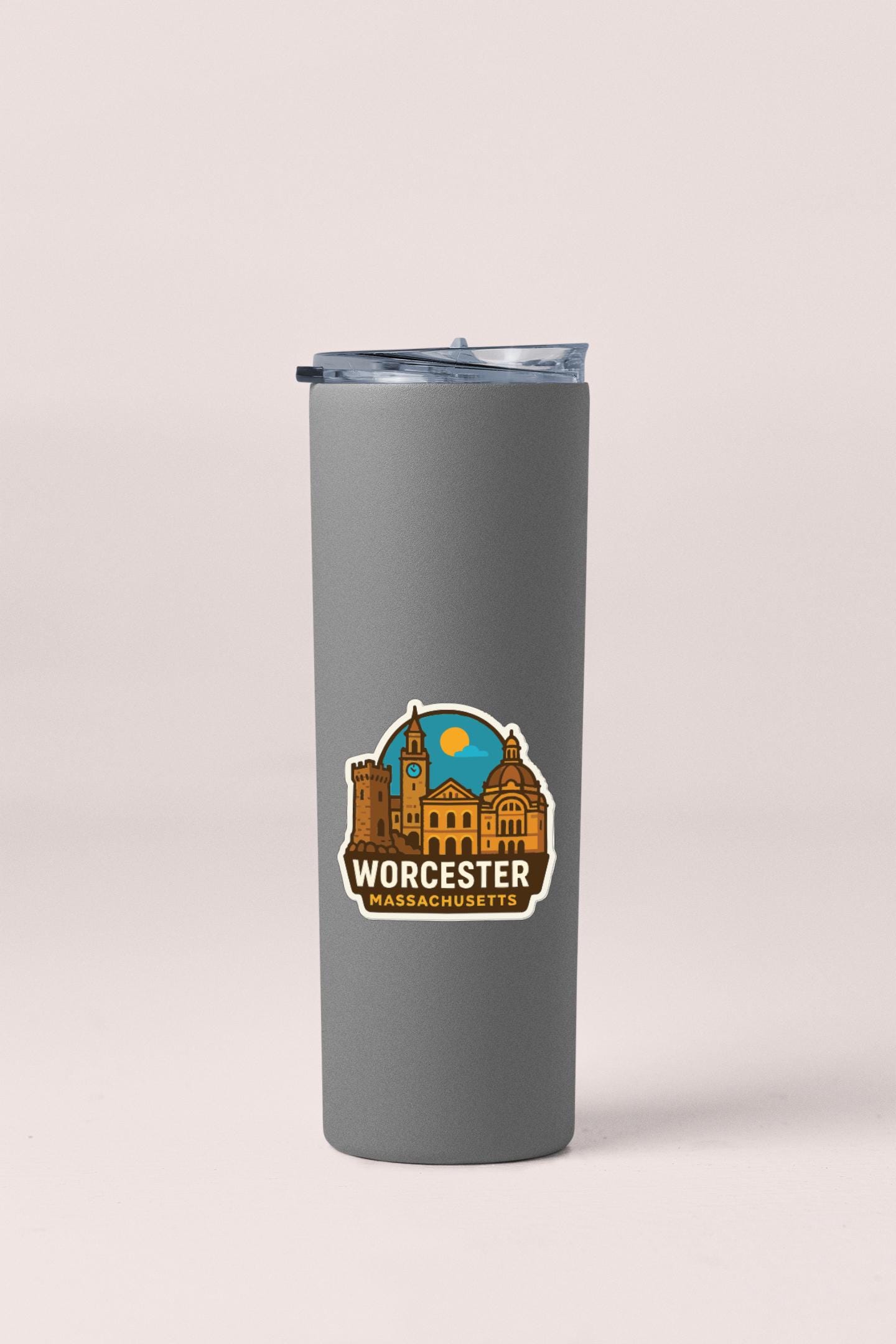 A gray insulated tumbler with a sticker depicting the Worcestershire, Massachusetts, skyline.