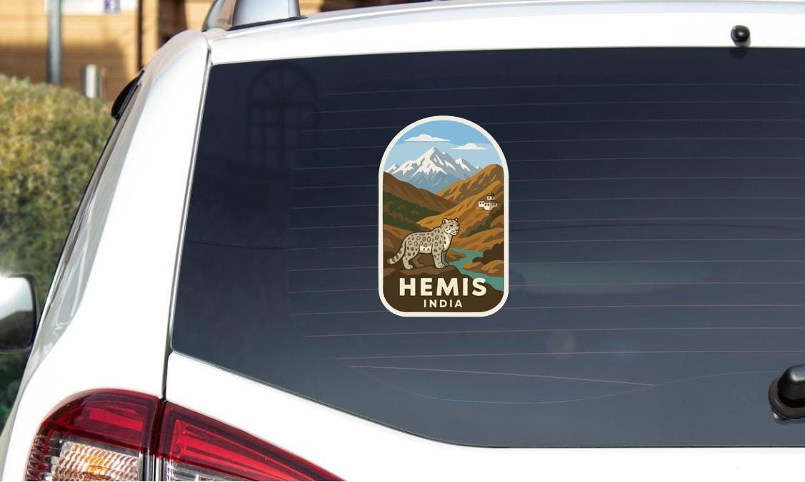 a sticker on the rear window of a car that says "HEMIS INDIA".