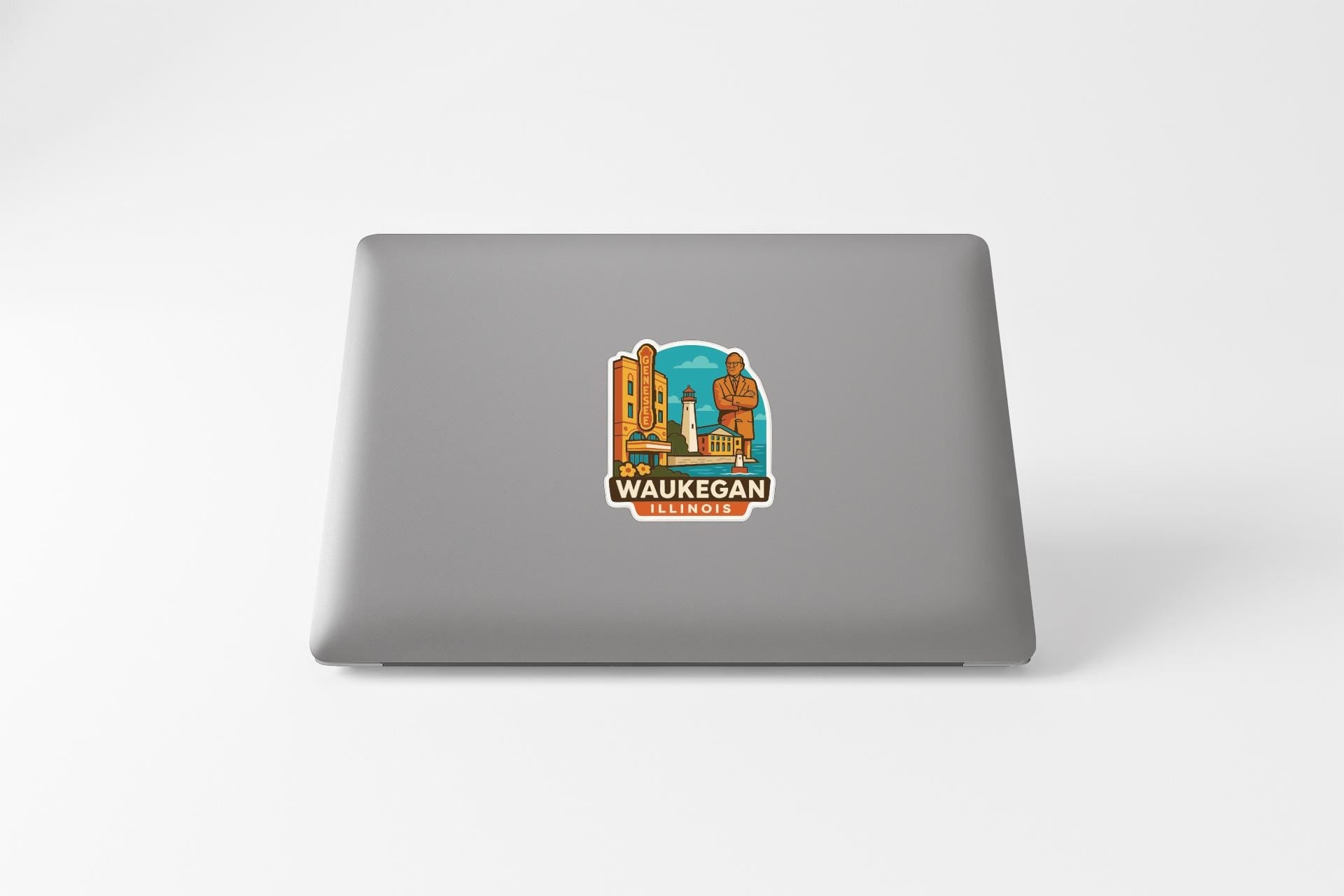 a sticker of Waukegan, Illinois on the back of a laptop.