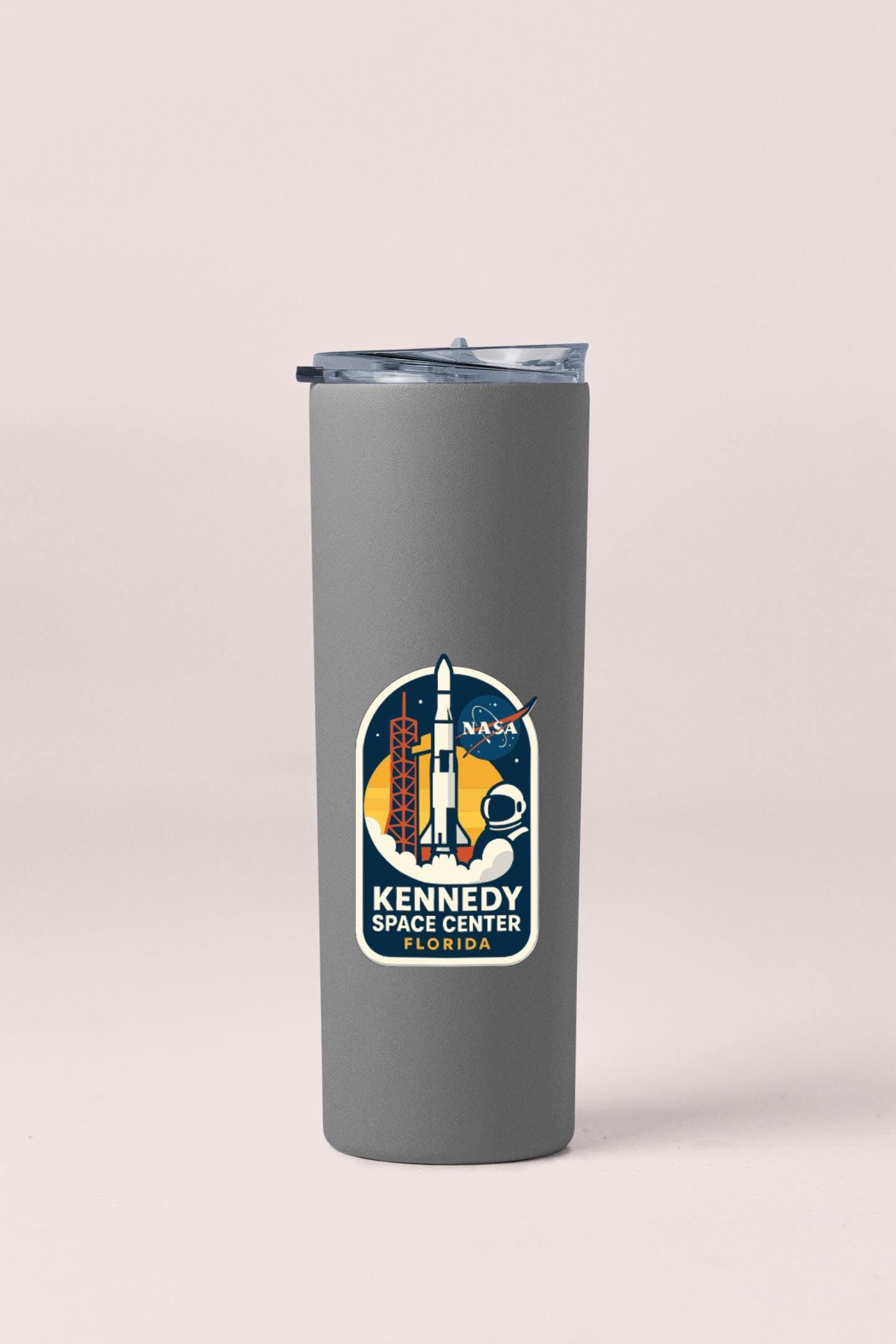 A gray tumbler with a NASA Kennedy Space Center Florida logo printed on it.