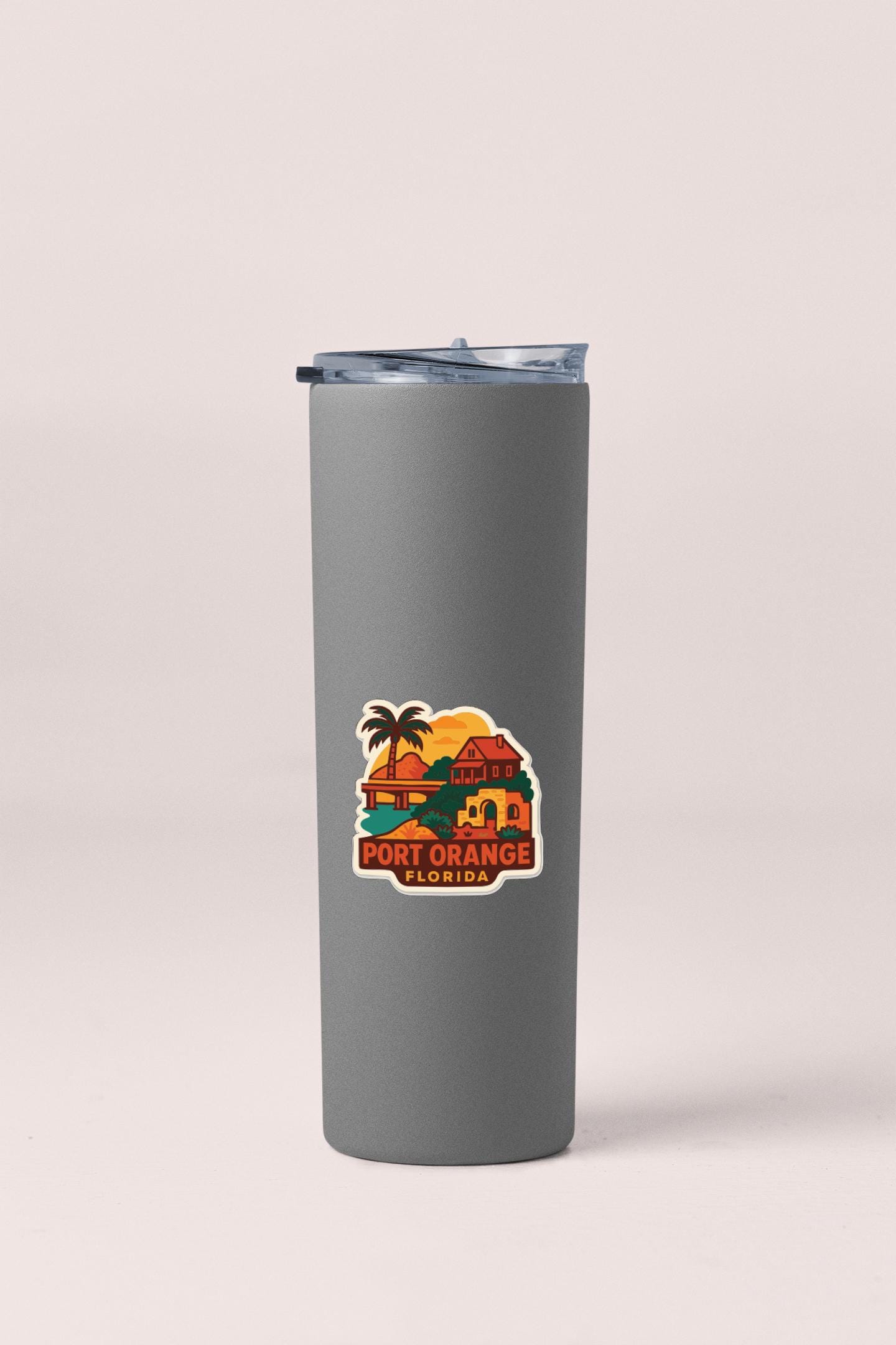 A gray insulated tumbler with a printed sticker depicting a tropical beach scene and the text "PORT ORANGE FLORIDA".