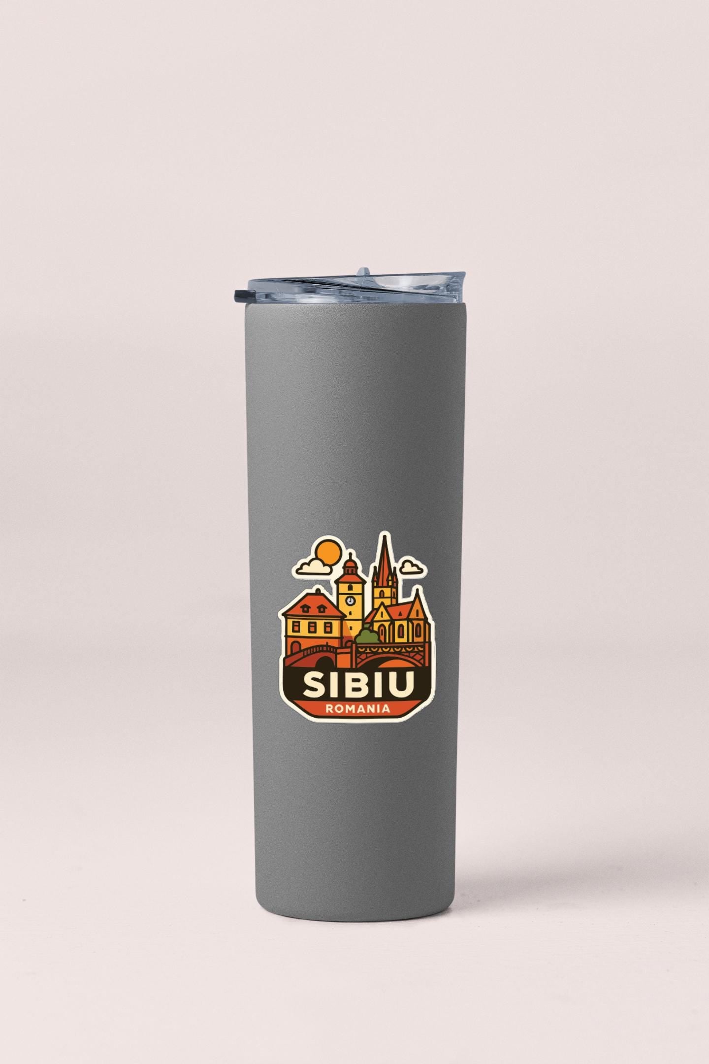 A gray insulated tumbler with a sticker depicting the city of Sibiu, Romania.