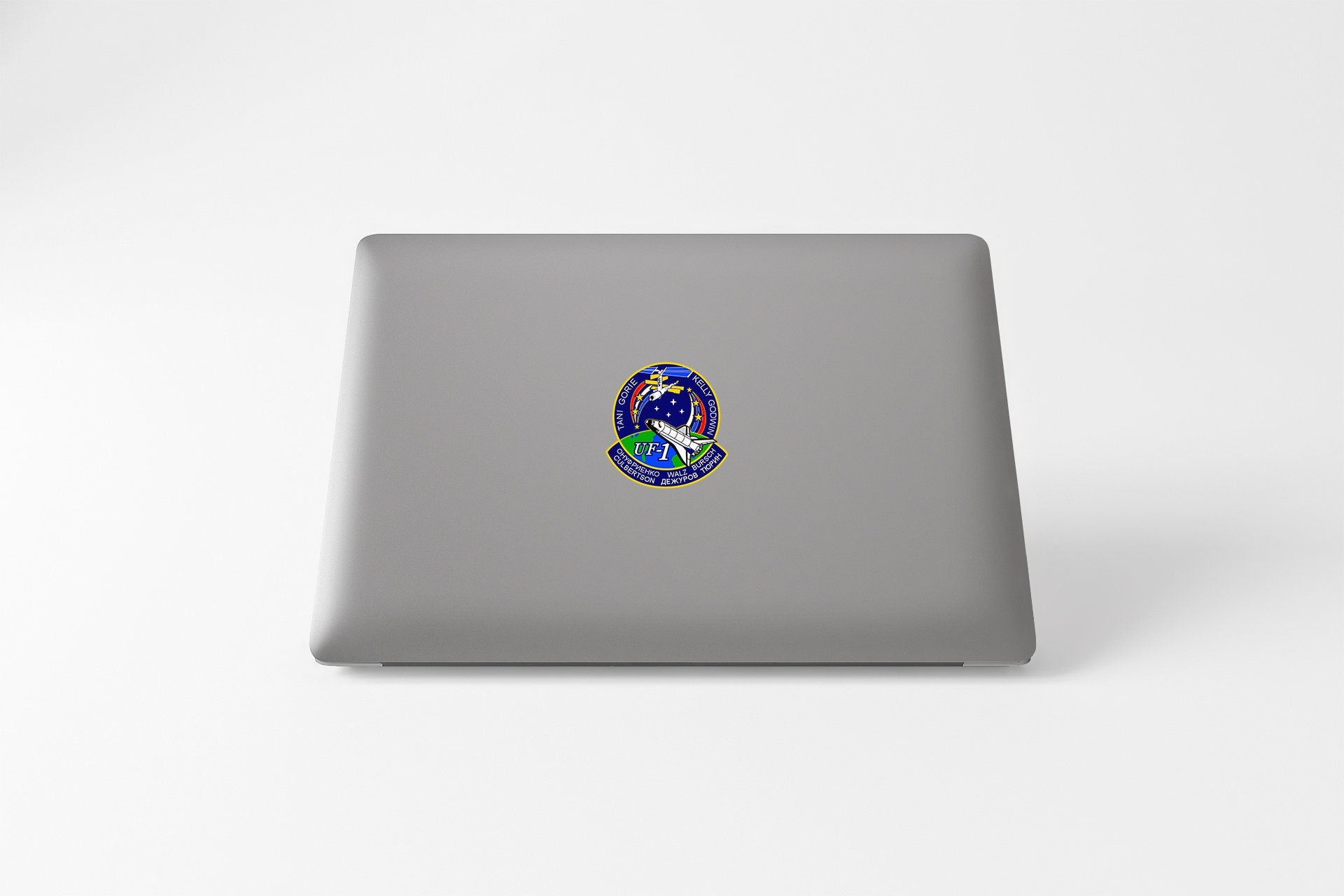 a laptop with a sticker of a bird on it