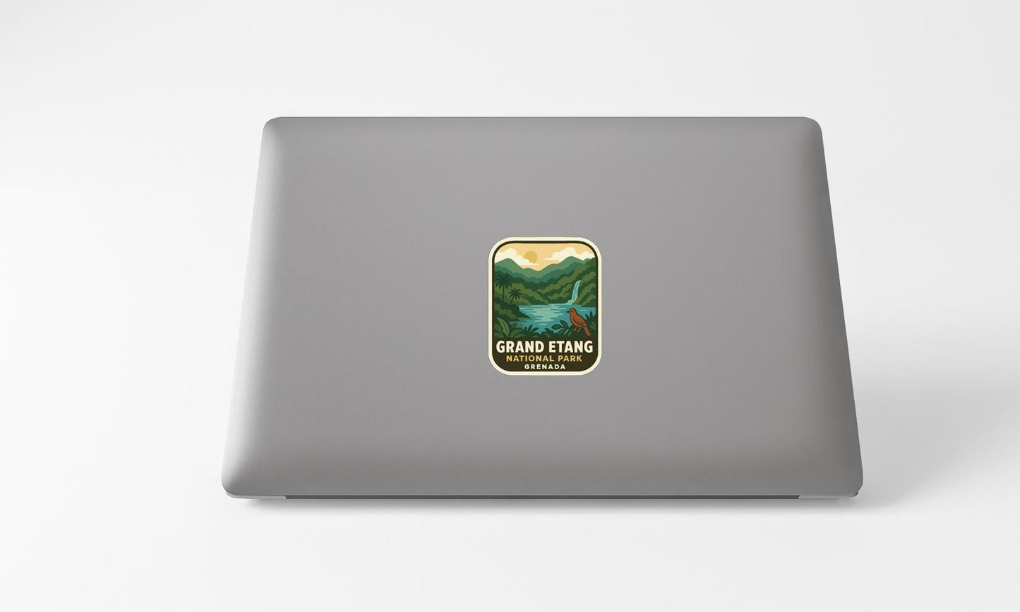 A sticker on the back of a laptop displaying a scenic landscape with mountains and a waterfall.