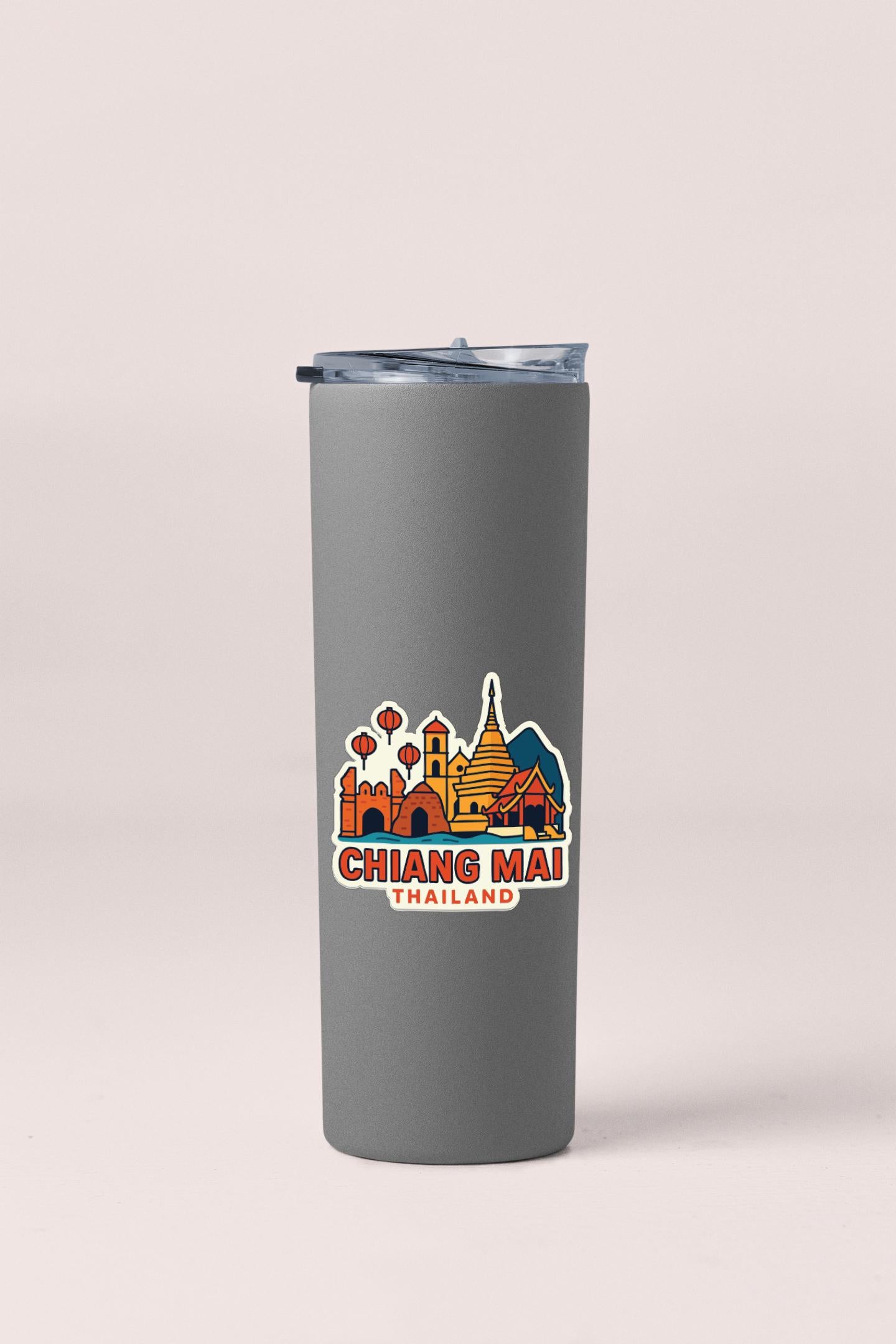 A gray insulated tumbler with a printed sticker depicting the skyline of Chiang Mai, Thailand.