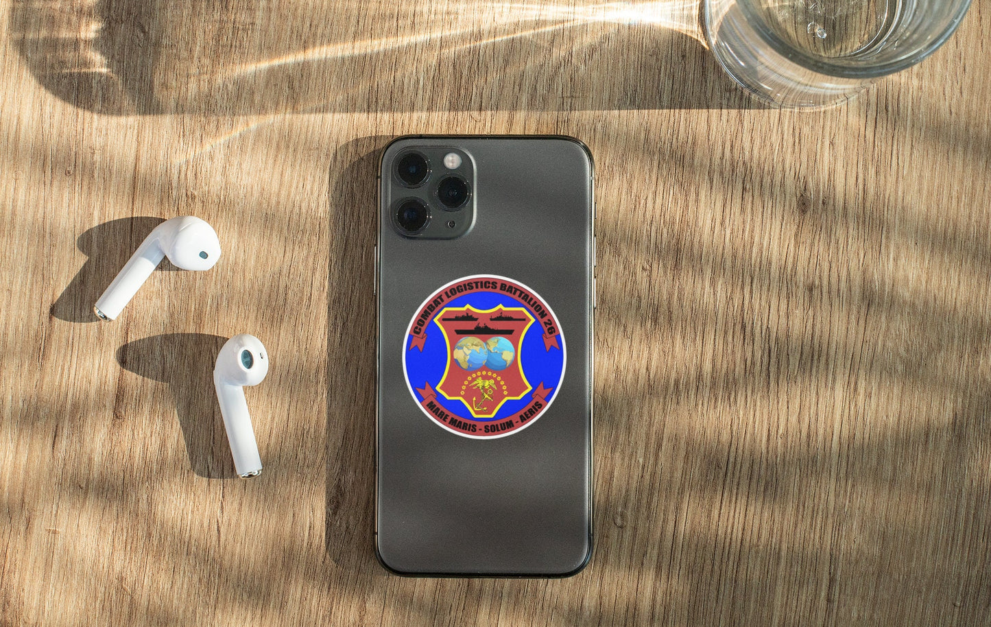a cell phone sitting on top of a wooden table