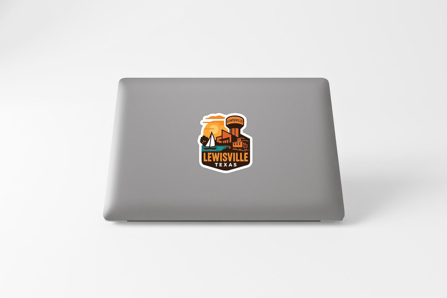 A sticker on the back of a laptop displaying the text "LEWISVILLE" and an illustration of a water tower.
