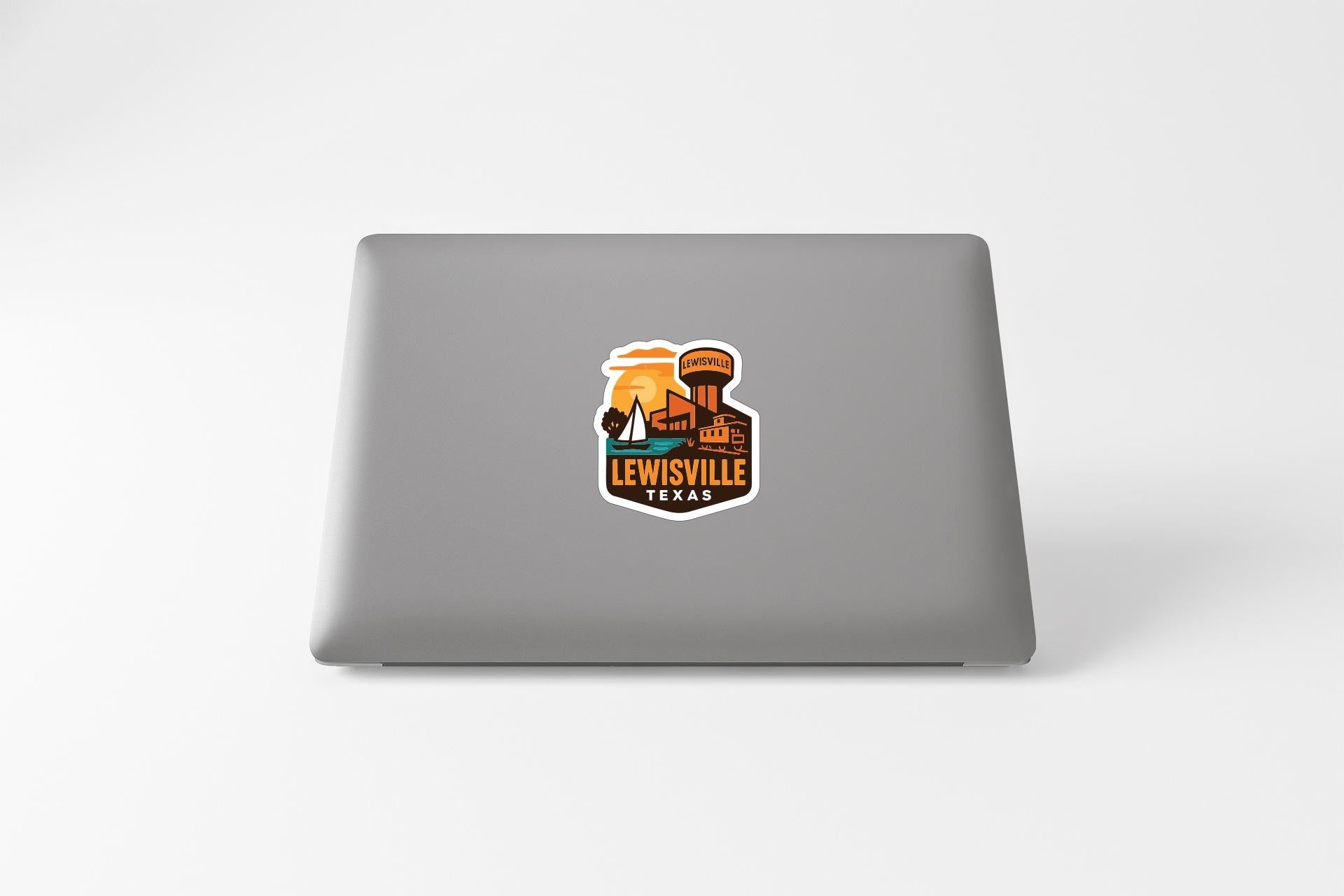 A sticker on the back of a laptop displaying the text "LEWISVILLE" and an illustration of a water tower.