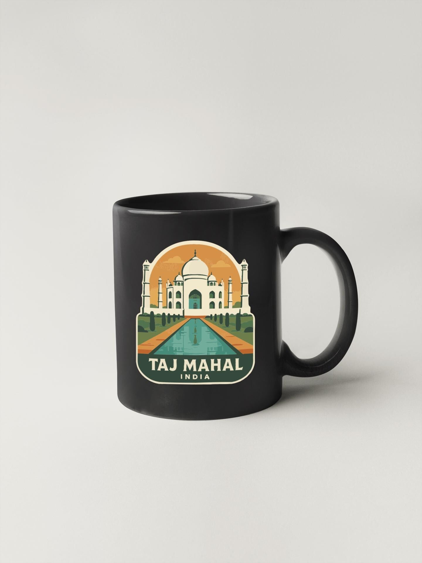 A black coffee mug with a graphic design featuring the Taj Mahal, a famous landmark in India.