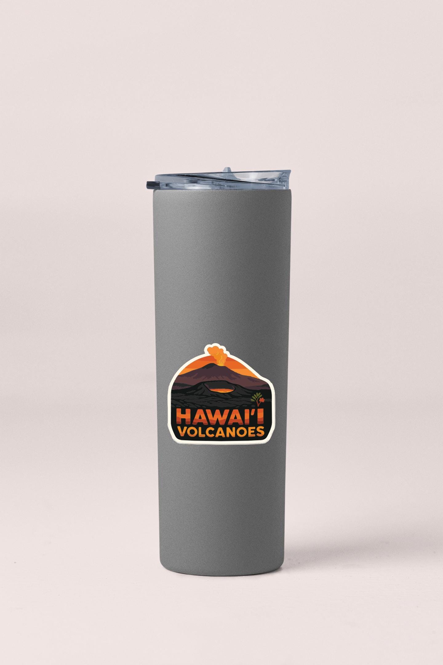 A gray insulated tumbler with a sticker that says "Hawaii Volcanoes".