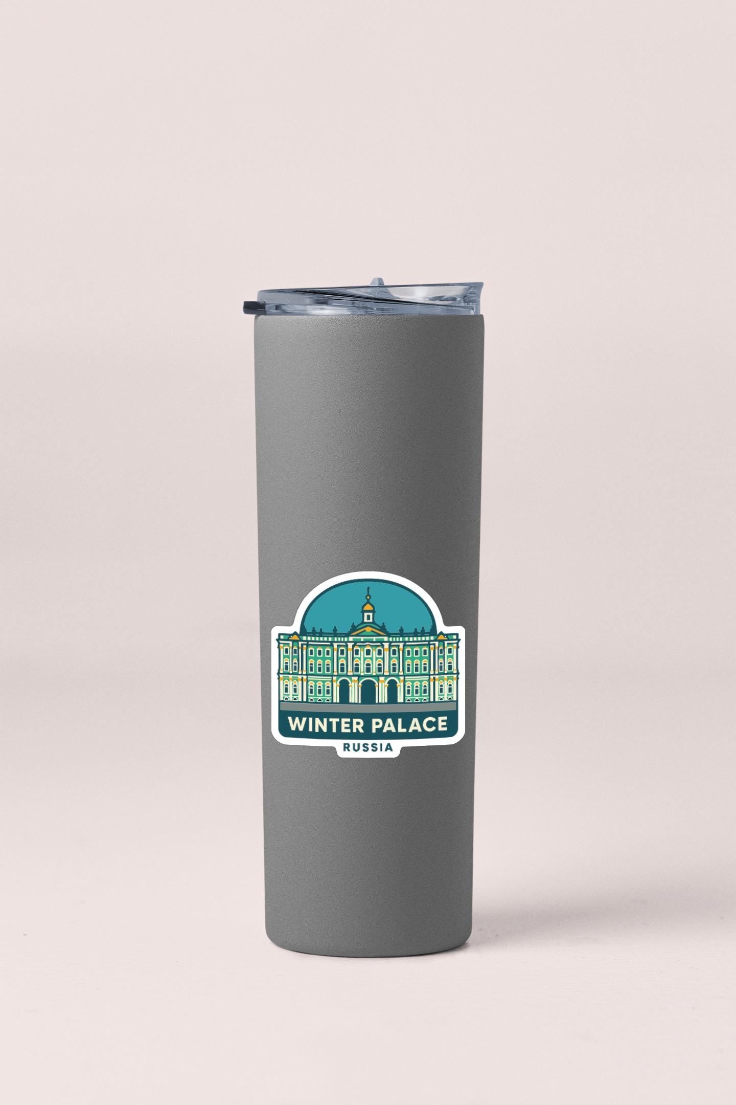 A gray insulated tumbler with a sticker depicting the Winter Palace in Russia.
