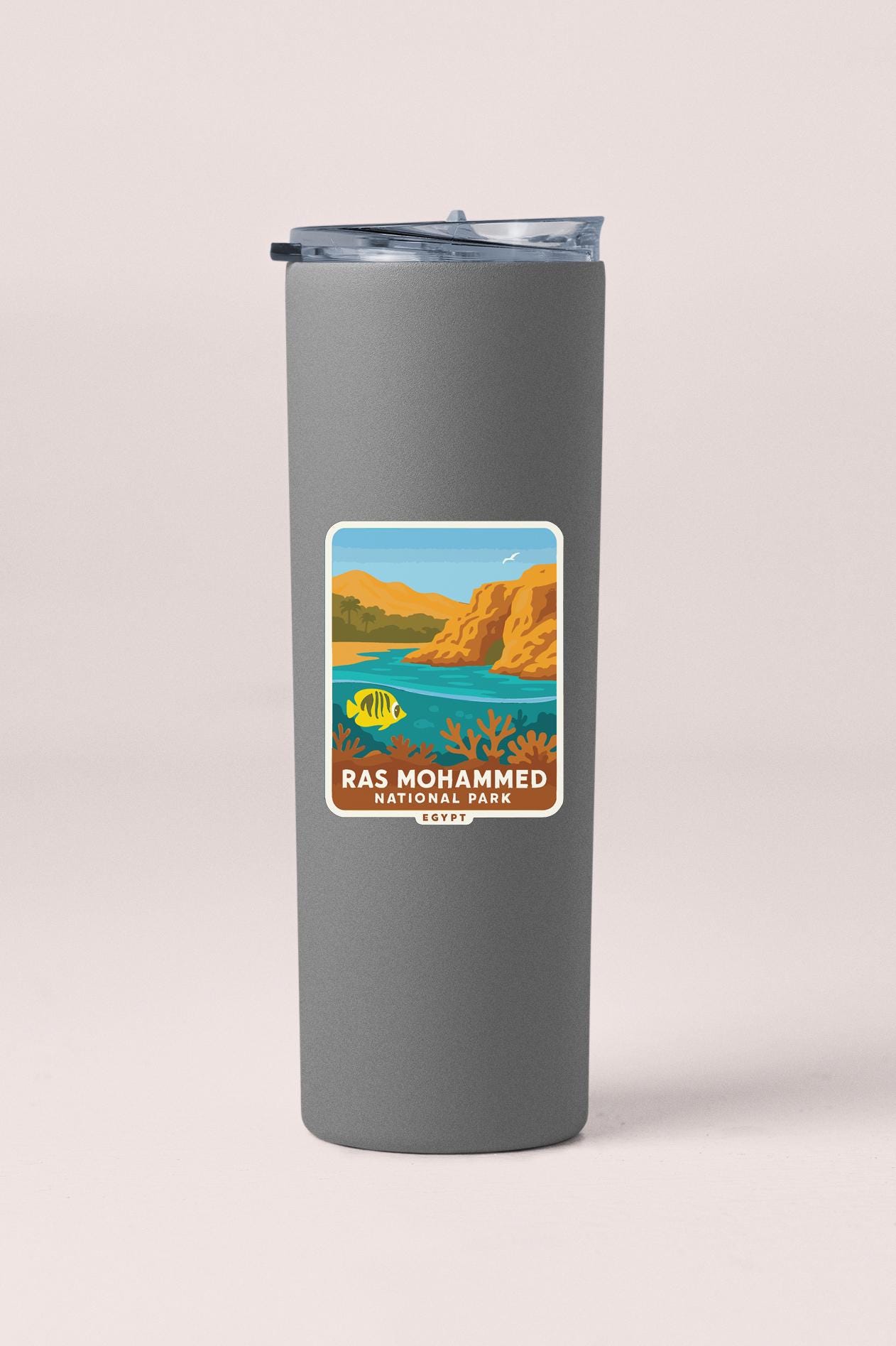 A gray insulated tumbler with a label that features an illustration of Ras Mohammed National Park in Egypt.