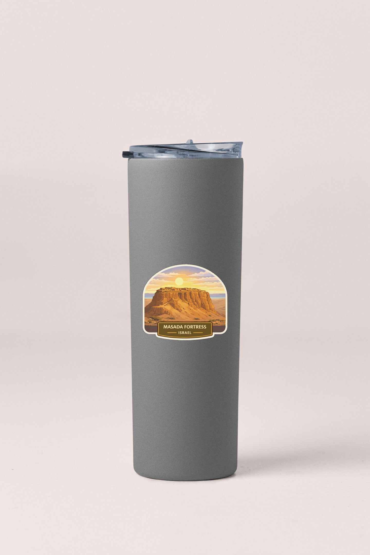 A gray insulated tumbler with a label that features a mountain landscape and the text "Mazda Fortress" and "Israel".