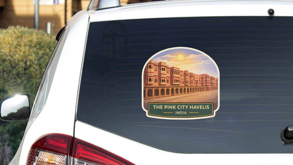 a sticker on the rear window of a car that displays a cityscape with buildings and a sunset.