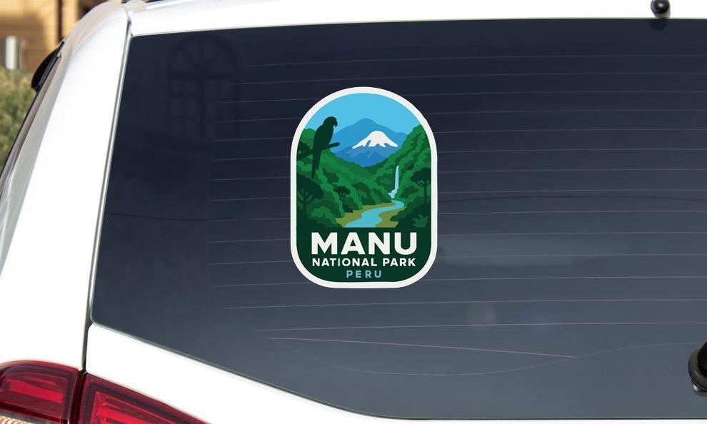 a sticker on the rear window of a vehicle that says "MANU NATIONAL PARK PERU".