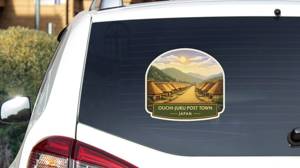 a sticker on the rear window of a car that says "OUCHIJUKU POST TOWN JAPAN".