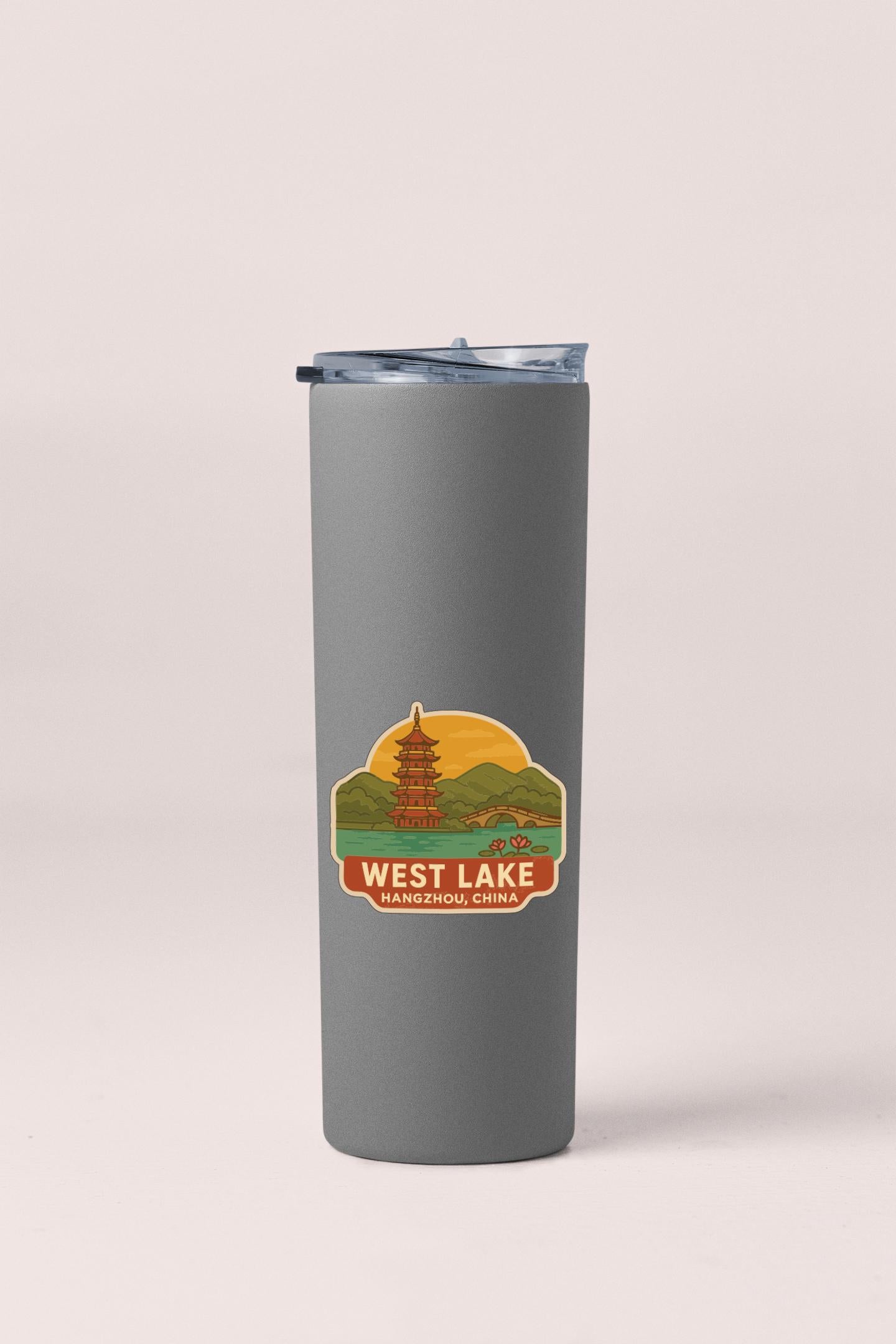 A gray insulated tumbler with a label that says "WEST LAKE HANGZHOU CHINA".