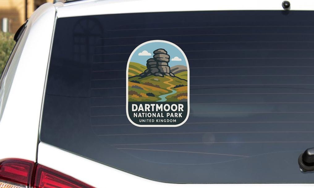 A sticker on the rear window of a car that says "Dartmoor National Park United Kingdom".