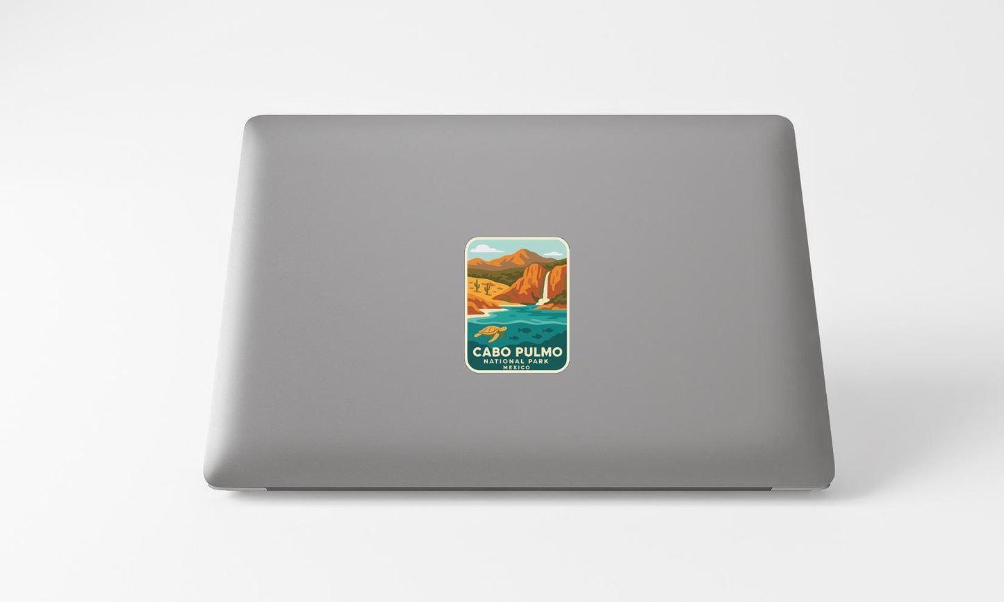 A sticker of a scenic landscape with mountains and a body of water, representing the Cardo Pulmo National Park.