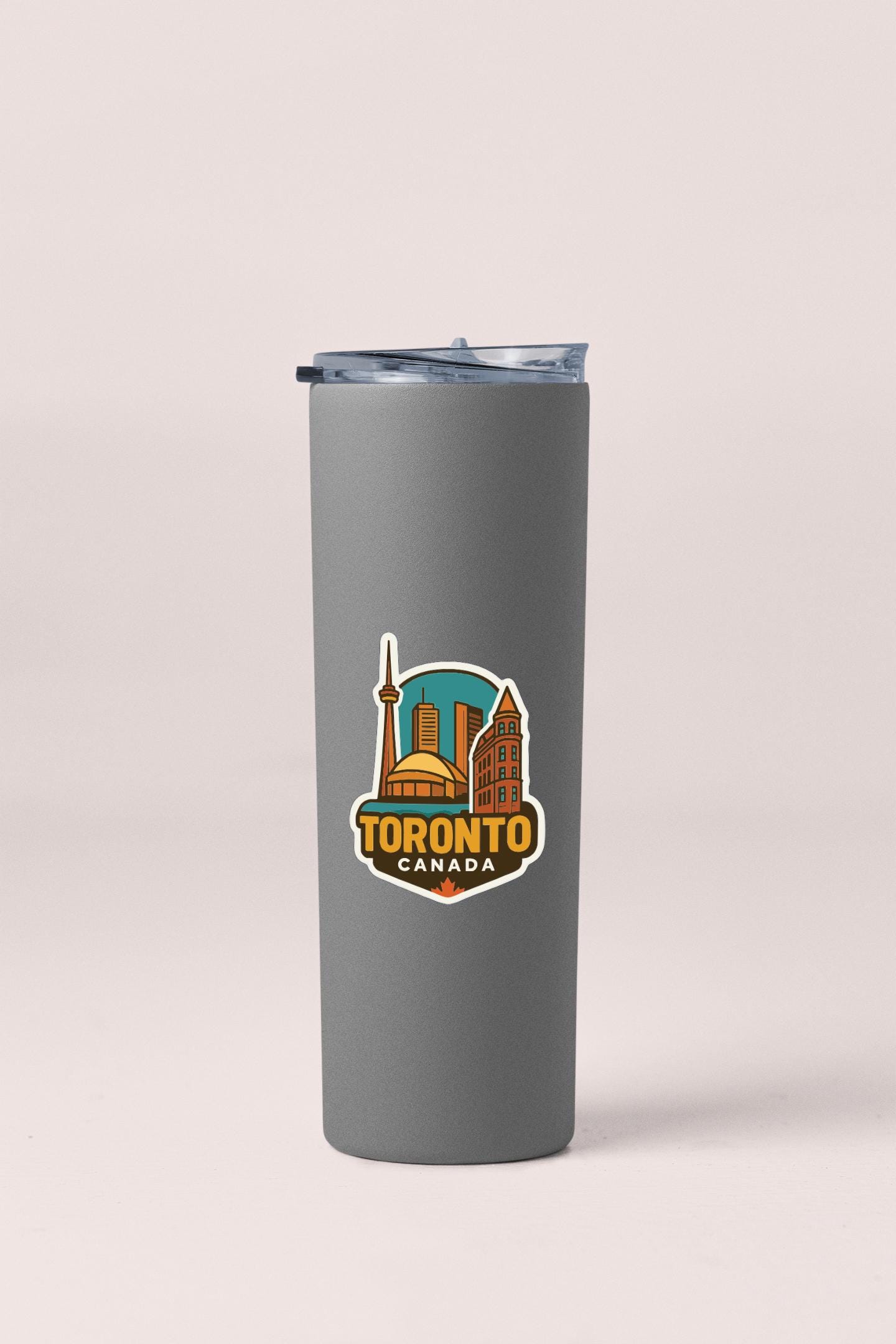 A gray insulated tumbler with a printed logo of Toronto, Canada.