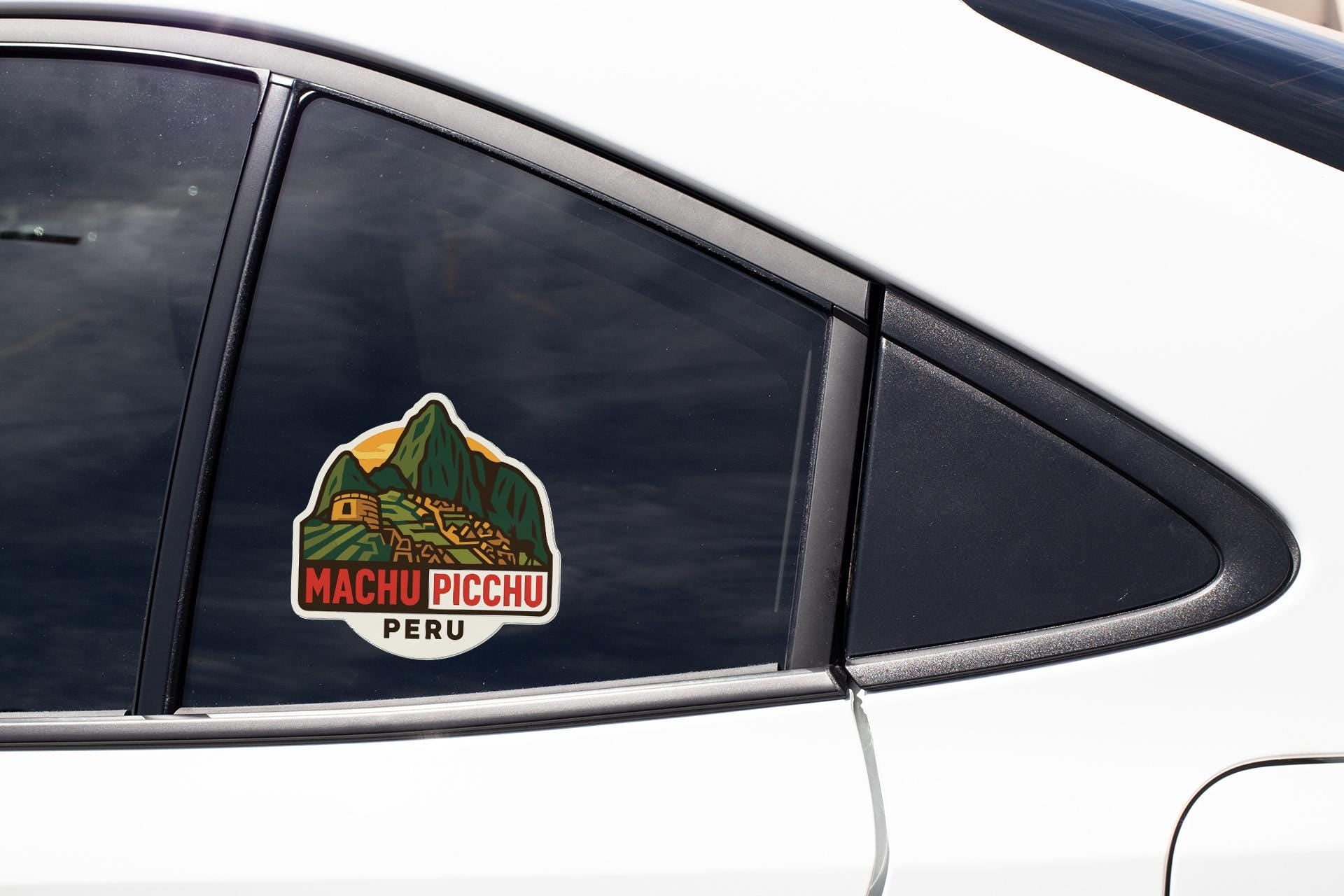 A sticker on the side of a car window, depicting Machu Picchu, the ancient Inca citadel located in Peru.