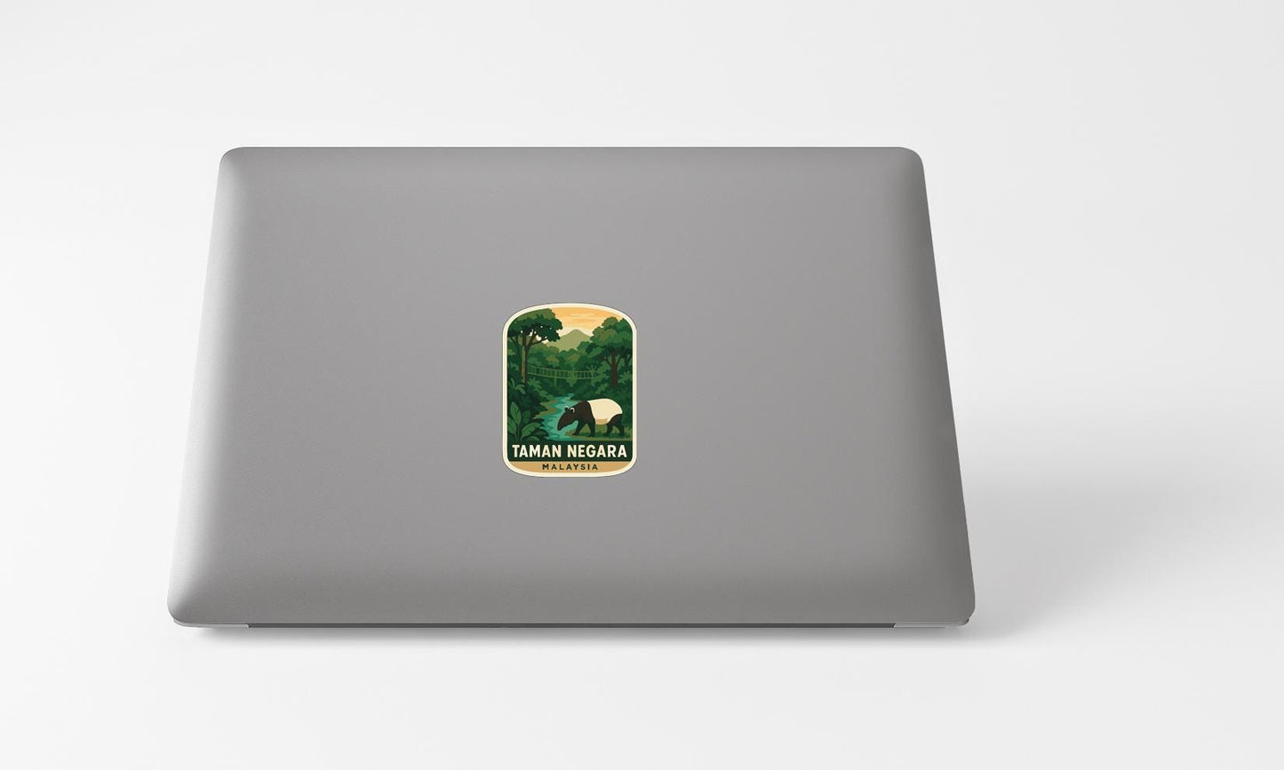A sticker with a tropical landscape on a laptop.
