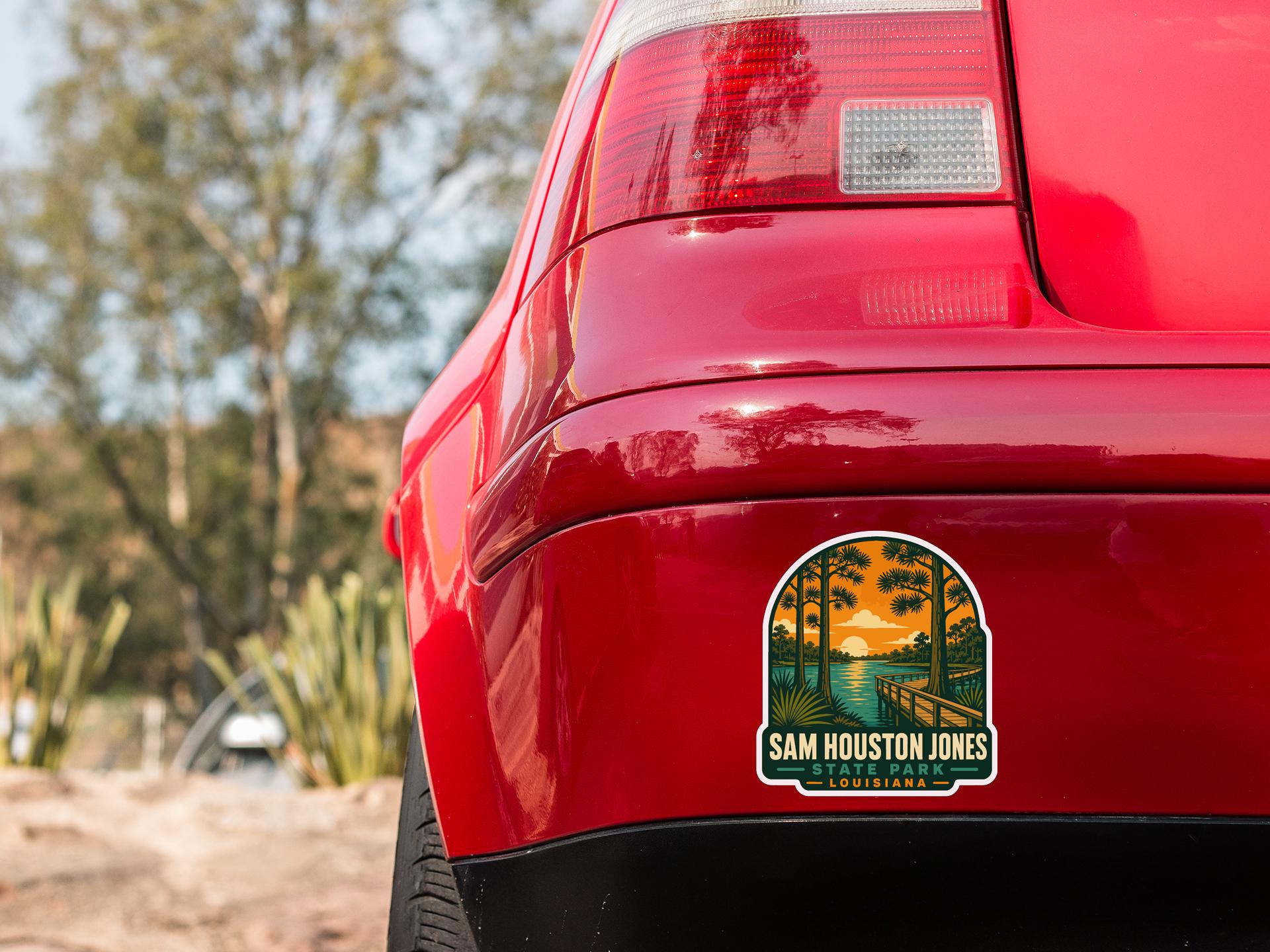 the rear end of a red car with a sticker on the back window that says "SAM HUSTON JONES LOUISIANA".