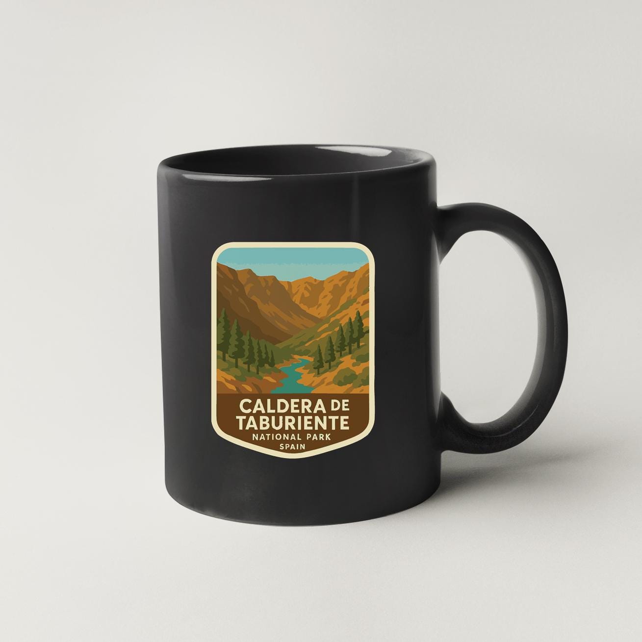 A black coffee mug with a label that says "CALDERA DE TABURIENTE NATIONAL PARK, SPAIN".