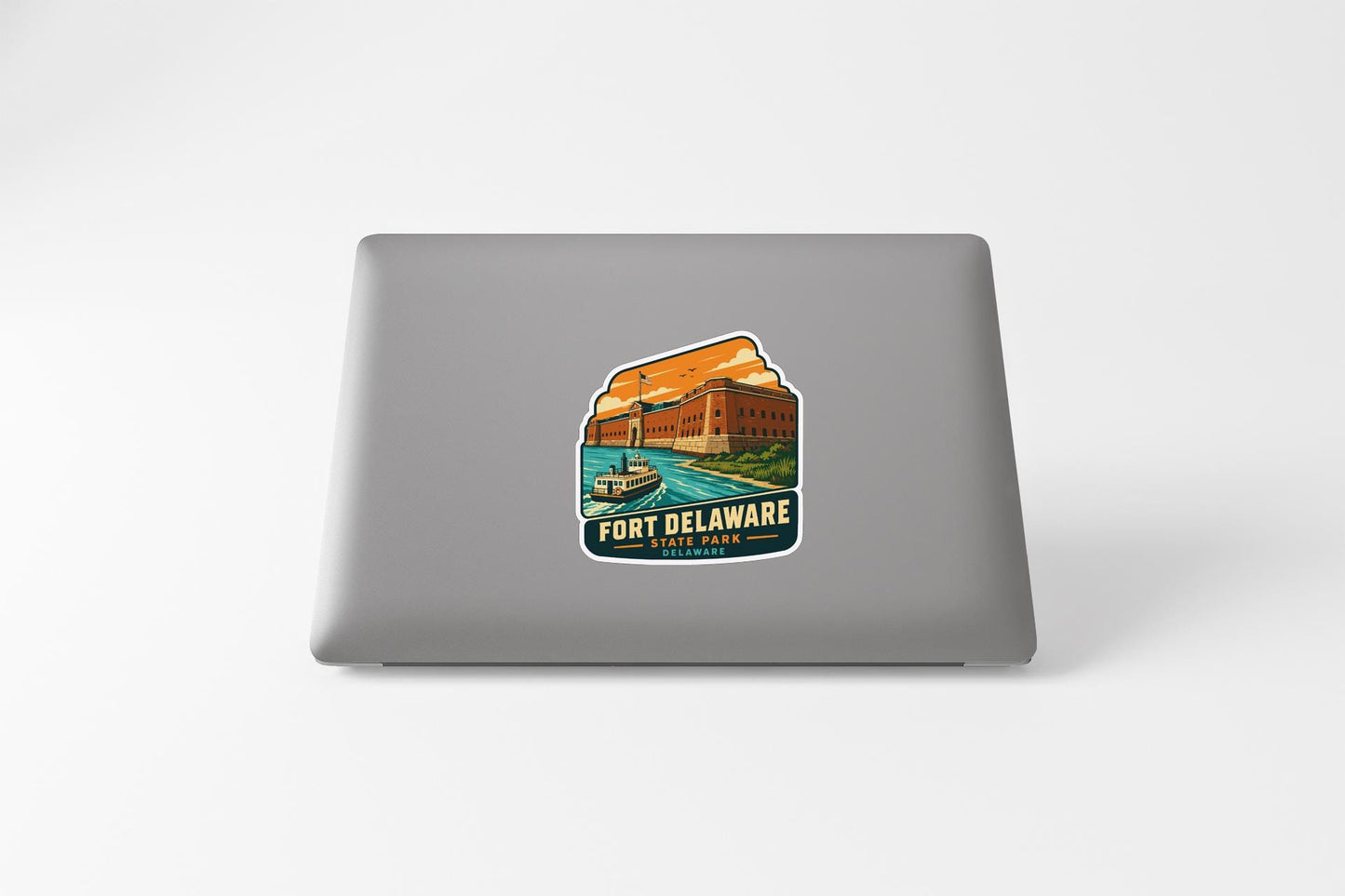 A sticker on the back of a laptop, depicting a scenic view of Fort Delaware State Park.