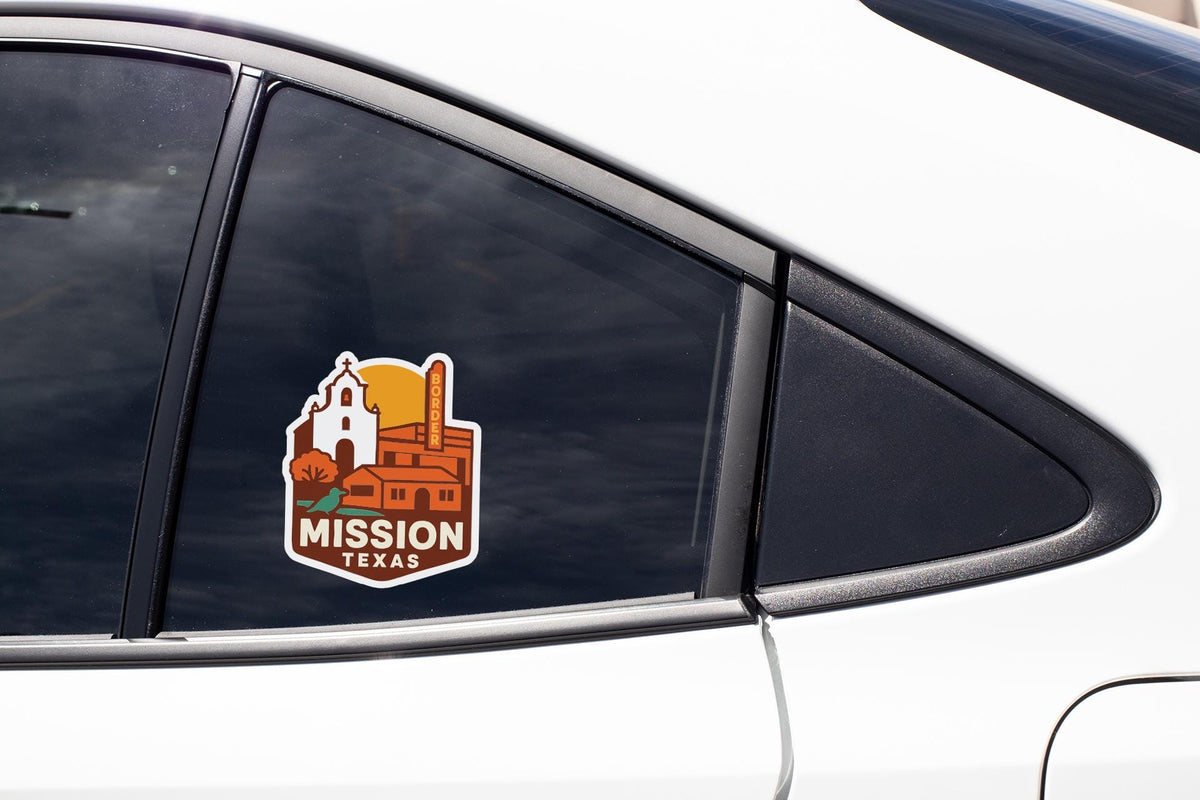A sticker on the side of a car window that says "MISSION TEXAS".