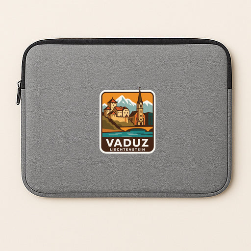 a gray laptop sleeve with a sticker of a scenic landscape and a mountain range.