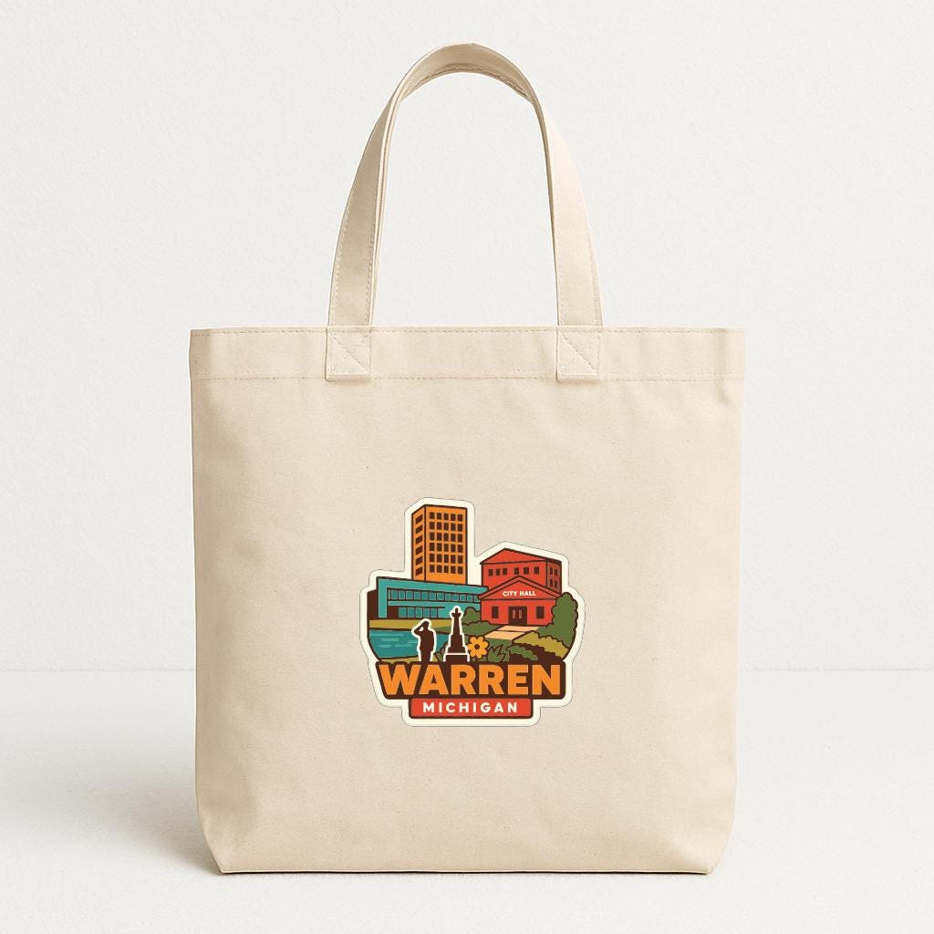A beige tote bag with a printed design depicting a cityscape and the text "WARREN MICHIGAN".