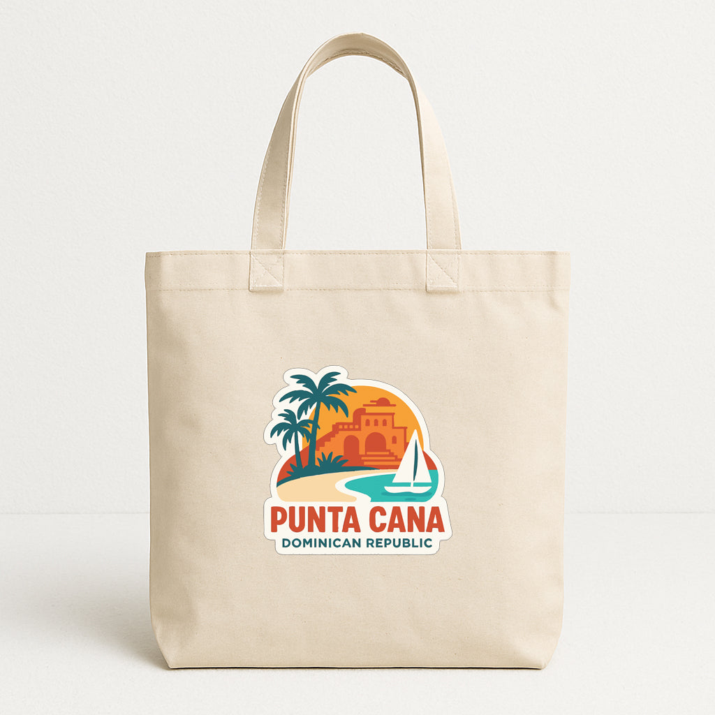 A beige tote bag with a graphic design featuring a tropical island, palm trees, and a sailboat, along with the text "PUTA CANA DOMINICIAN REPUBLIC".